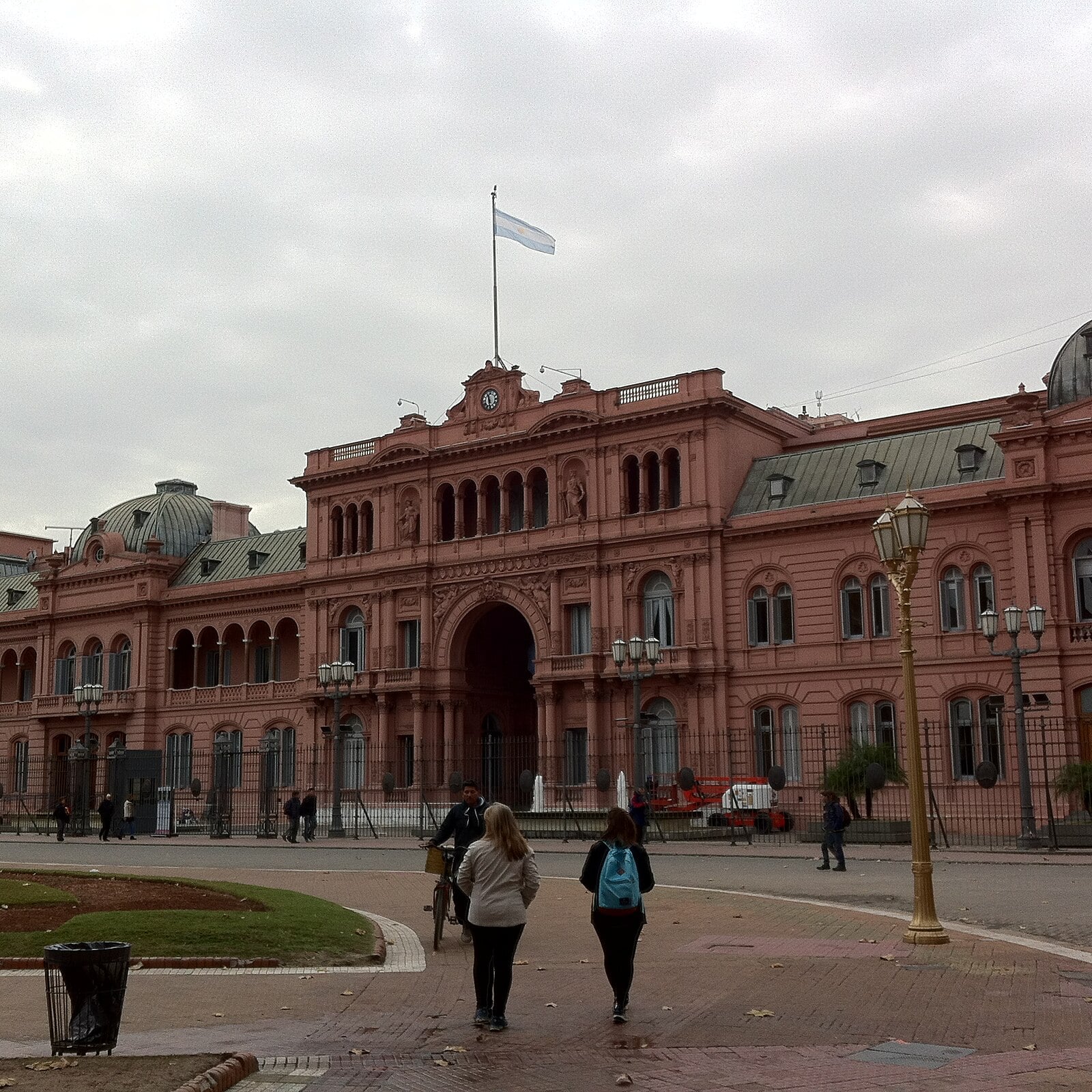 The pink Casa Rosada presidential palace in Buenos Aires with the Argentine flag flying, seen from Plaza de Mayo
