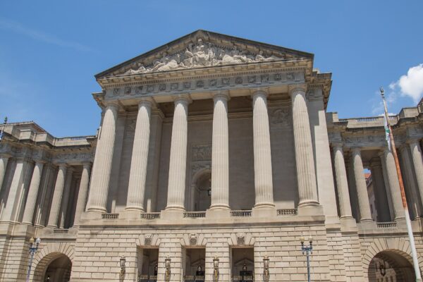 Columned facade of the Andrew W. Mellon Auditorium on Constitution Avenue in Washington, D.C.