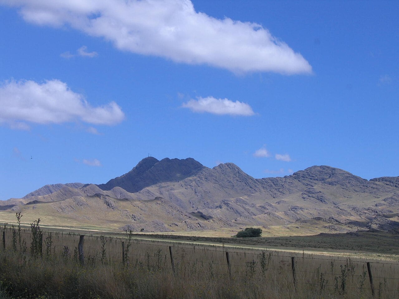 Fenced rural land and hills near Pigüé in Buenos Aires province, Argentina