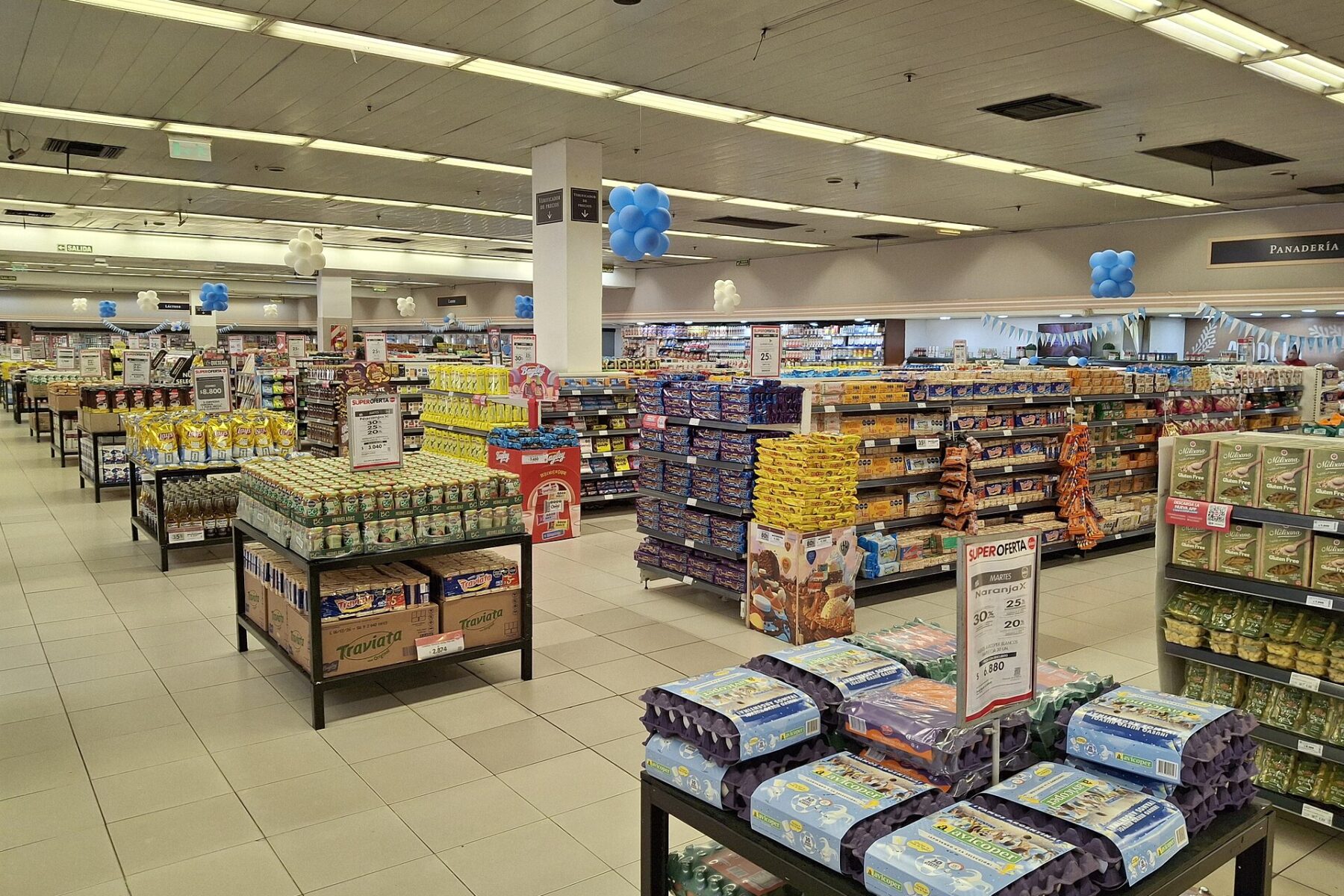 Shelves and price signs inside a Disco supermarket in Morón, Buenos Aires Province, Argentina
