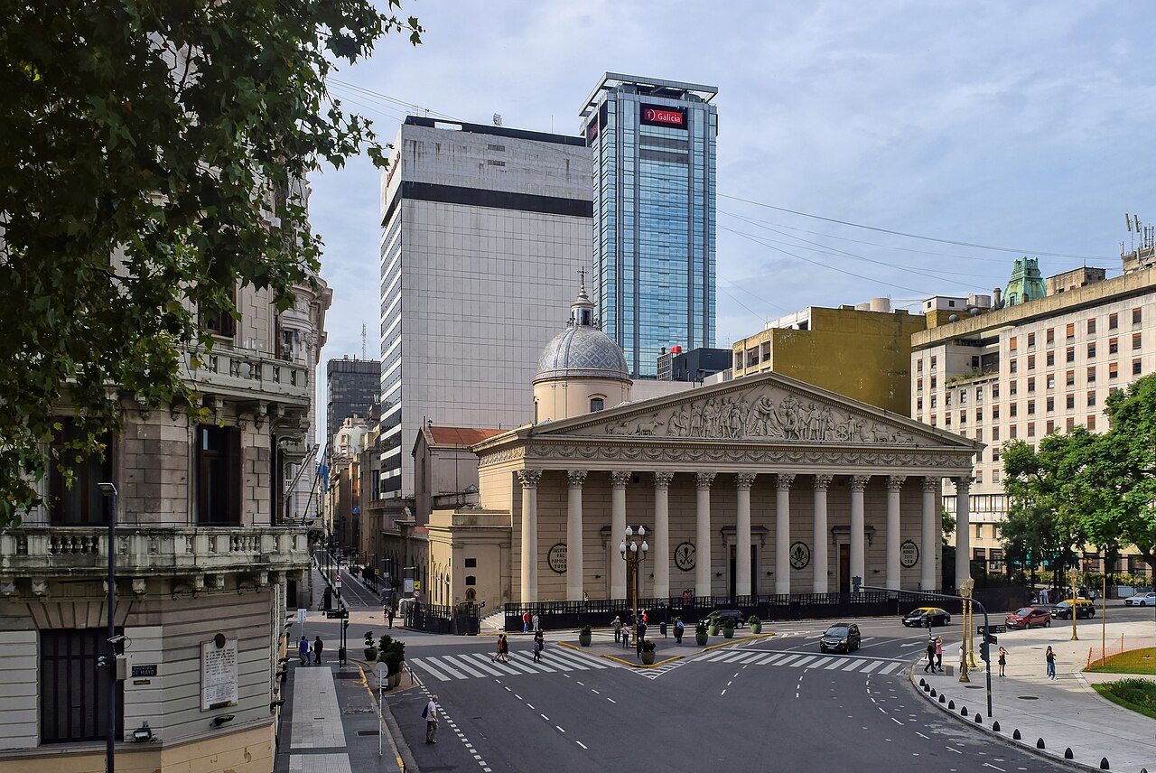 Columned neoclassical facade of the Buenos Aires Metropolitan Cathedral with office towers behind it
