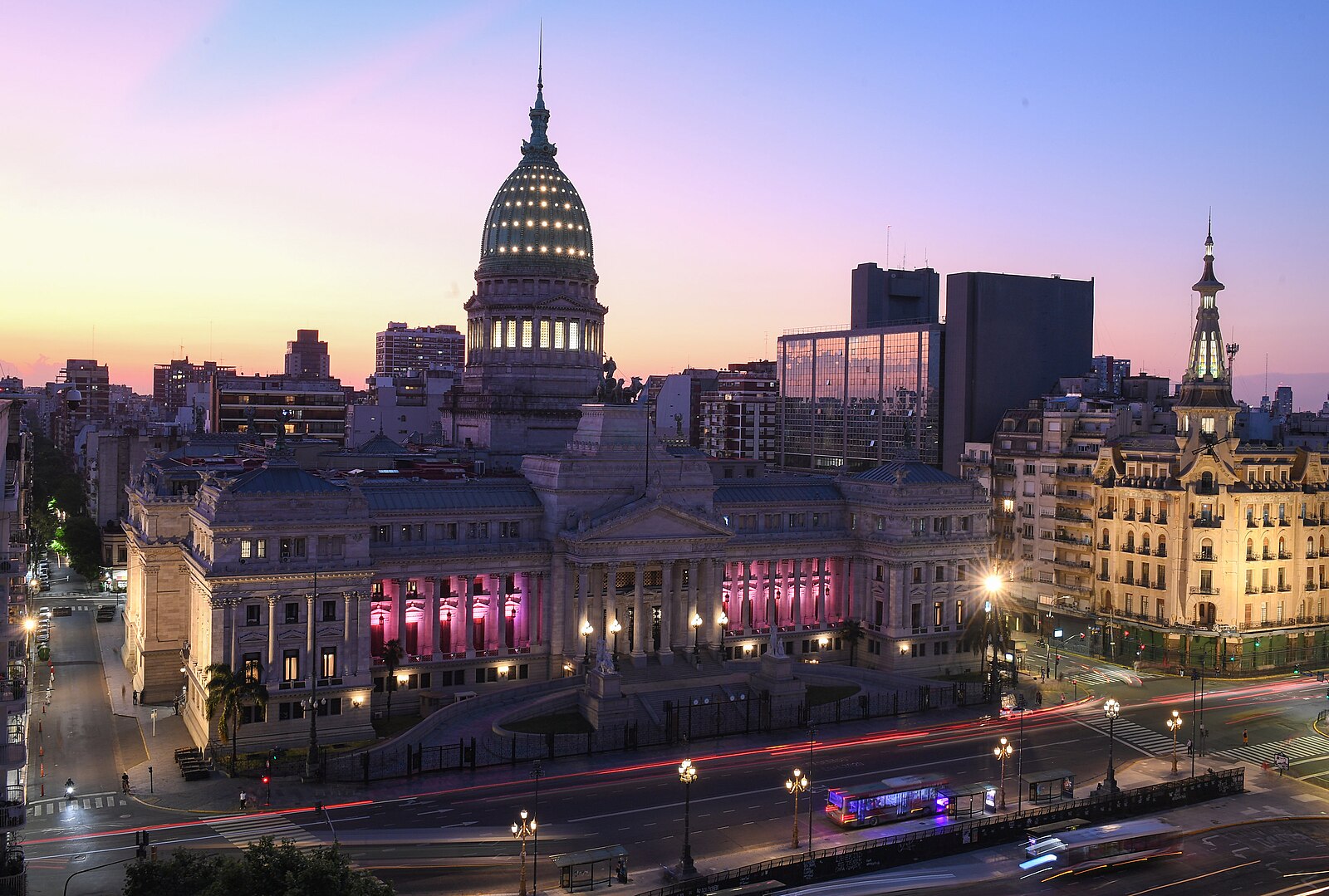 The Palace of the National Congress in Buenos Aires at dusk, with its colonnade lit pink