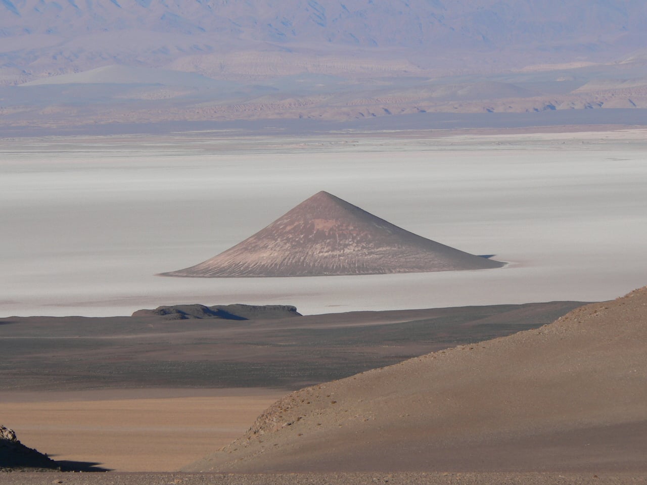 Cono de Arita, a volcanic cone rising from the Salar de Arizaro salt flat in Salta province, Argentina