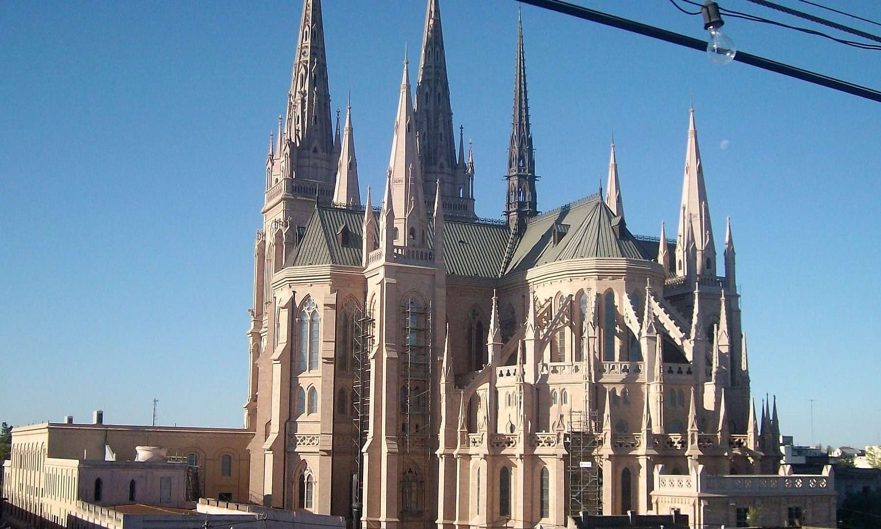 Gothic spires and apse of the Basilica of Our Lady of Luján in Buenos Aires province under a clear blue sky
