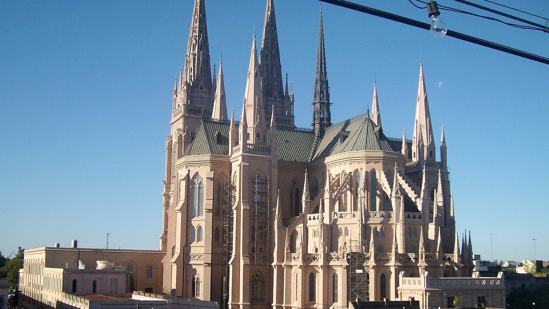 Gothic spires and apse of the Basilica of Our Lady of Luján in Buenos Aires province under a clear blue sky