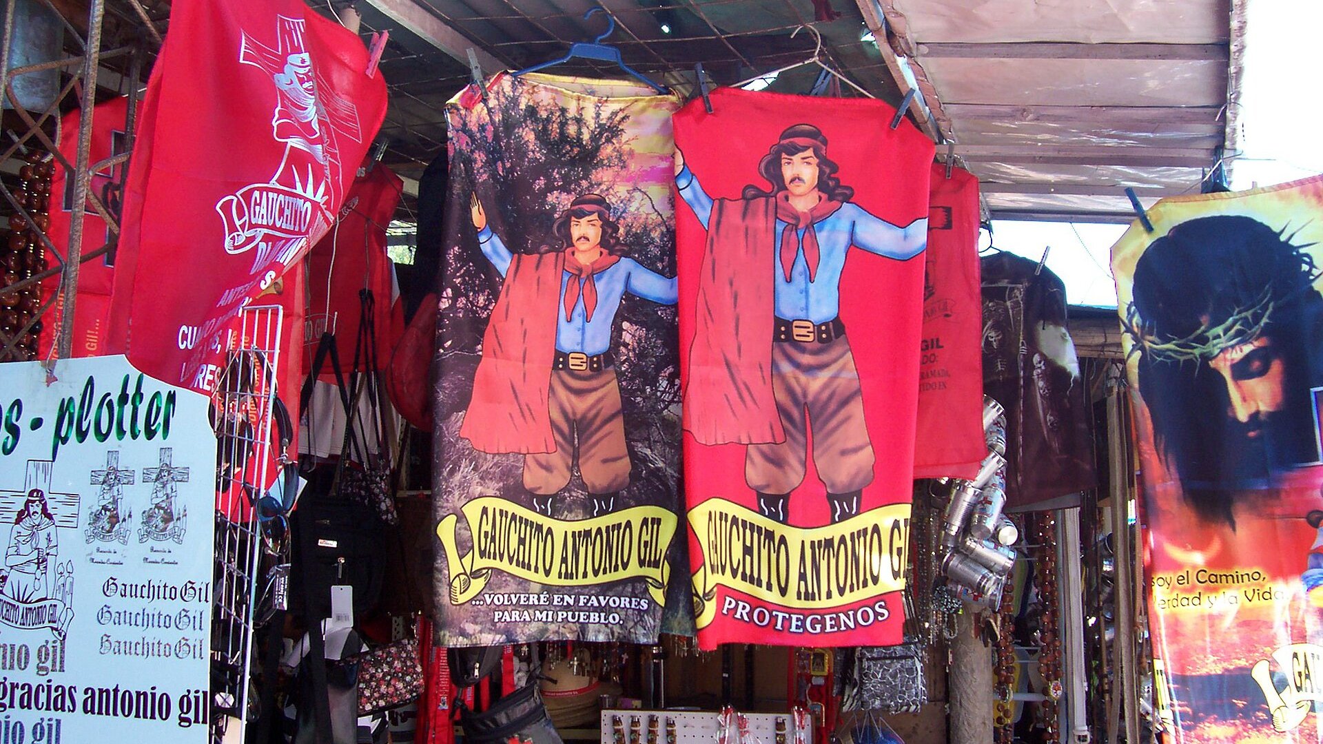 Red flags of the folk saint Gauchito Gil hanging at a souvenir stall at his shrine in Mercedes, Corrientes