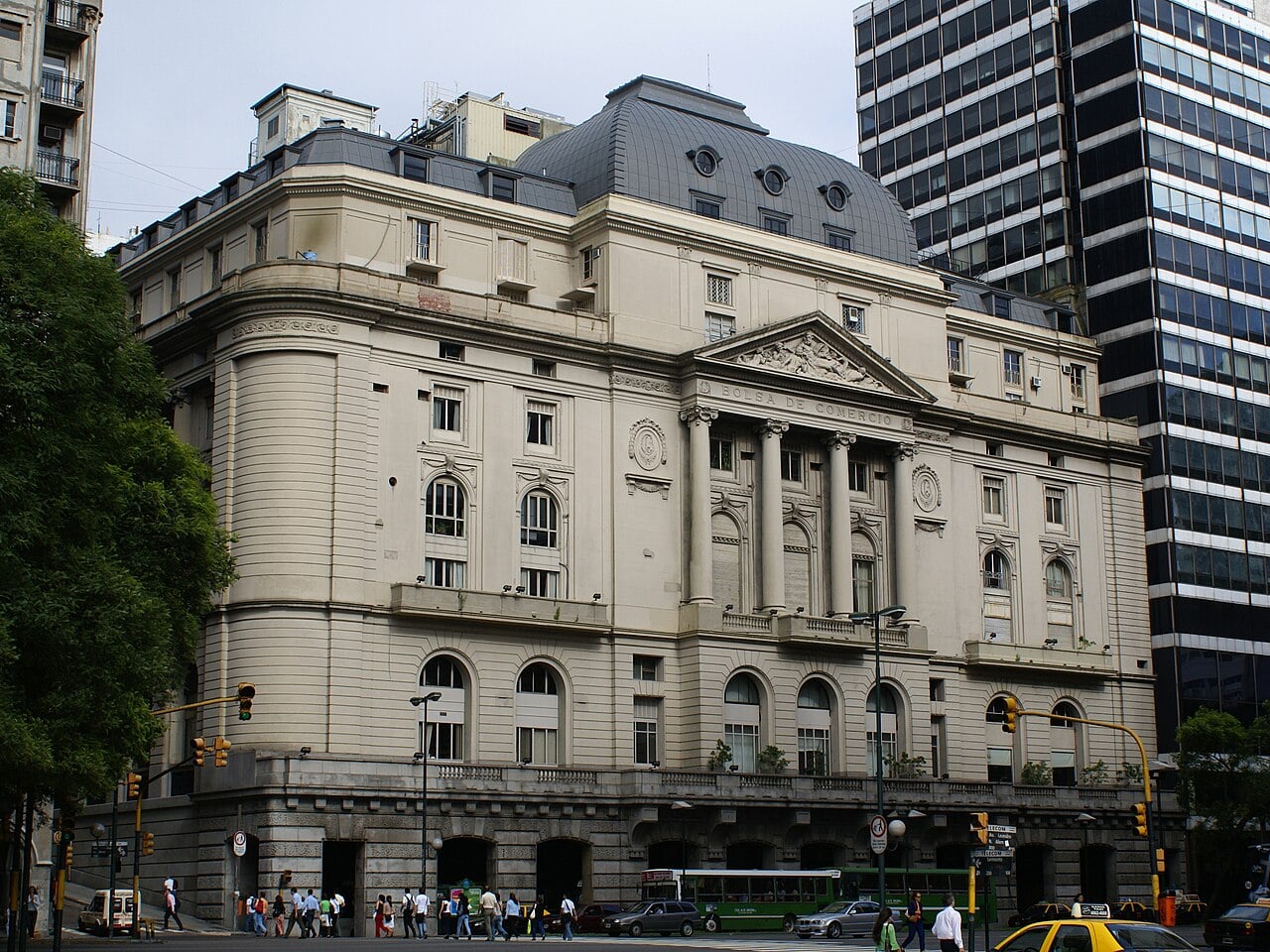 The Buenos Aires Stock Exchange building, a cream stone building with columns and a grey dome, on a city corner