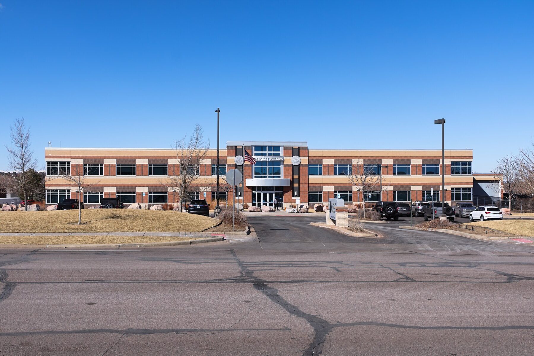 The two-storey brick Jim Bailey Building housing the ICE Denver Field Office in Centennial, Colorado, under a clear blue sky