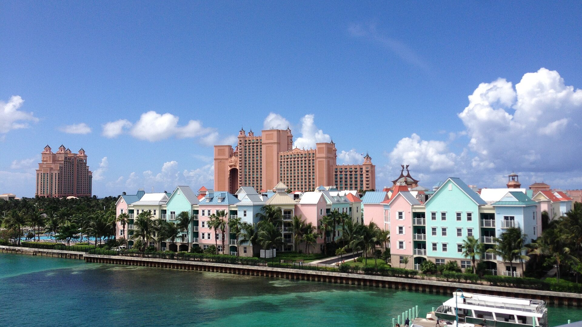 Pastel waterfront apartments and resort towers on Paradise Island in Nassau under a blue sky