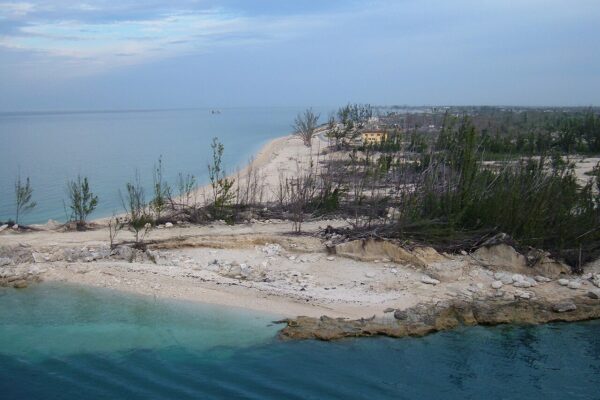 The rocky shore and sandy coast at the entrance to Freeport Harbour on Grand Bahama island