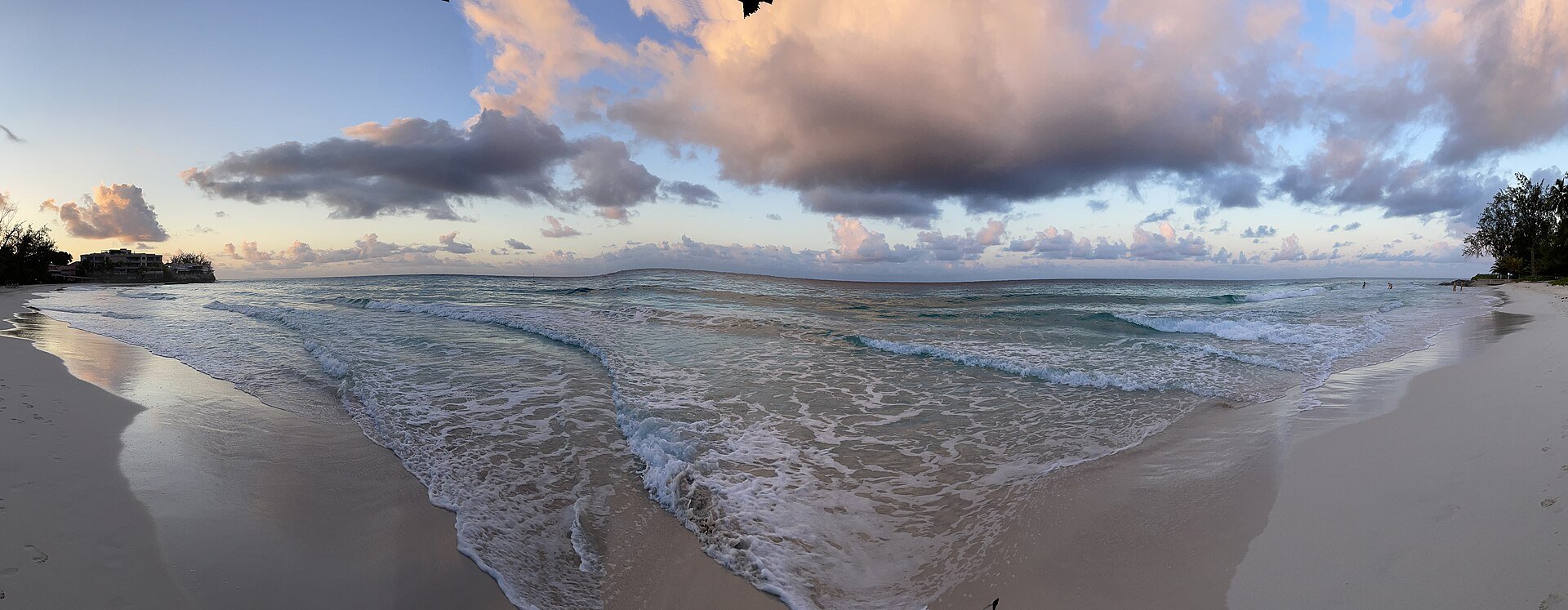 Waves washing onto the white sand of Accra Beach at dawn on the south coast of Barbados