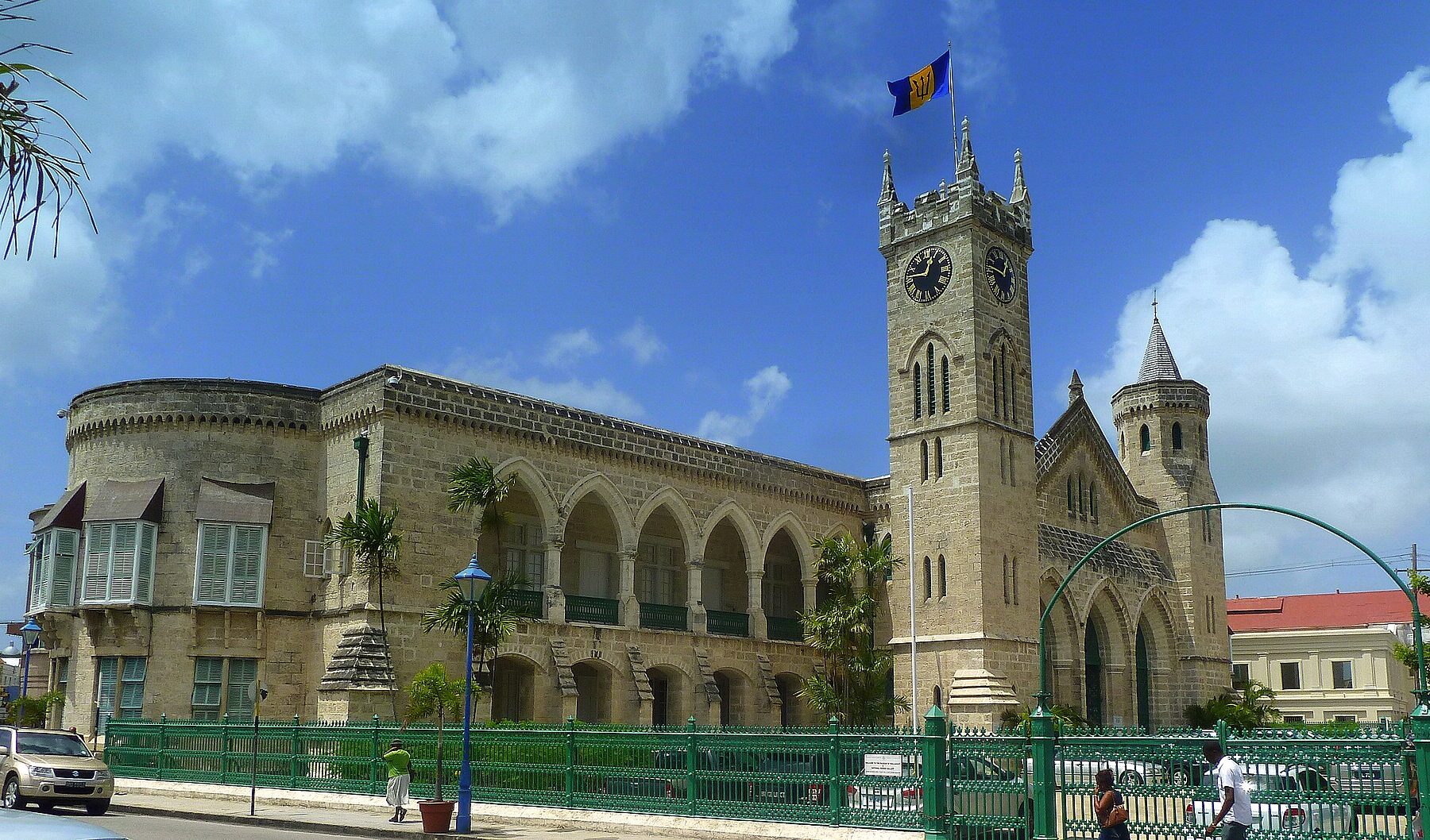 The west wing and clock tower of the Parliament Buildings in Bridgetown, Barbados, under a blue sky