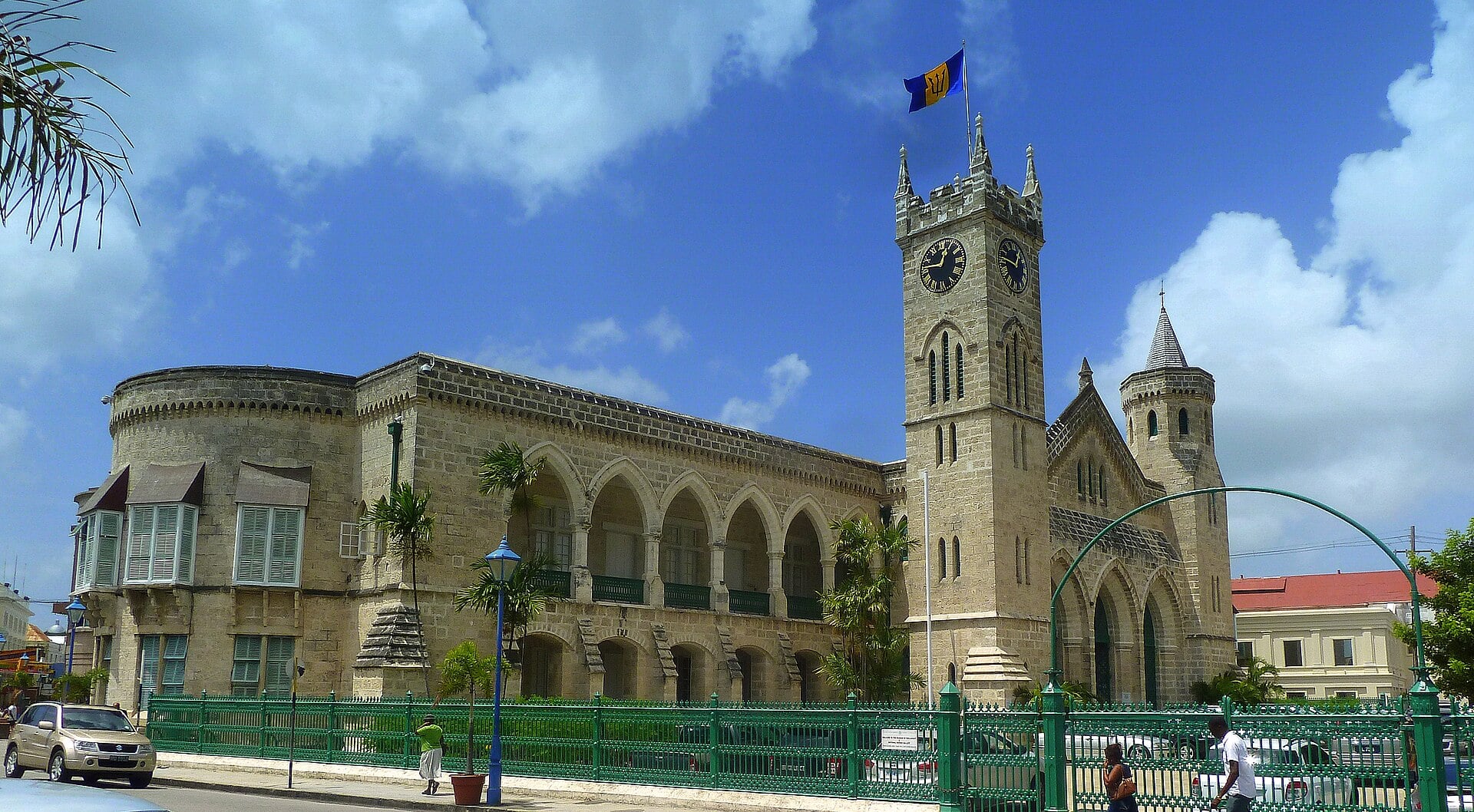 The west wing and clock tower of the Parliament Buildings in Bridgetown, Barbados, under a blue sky
