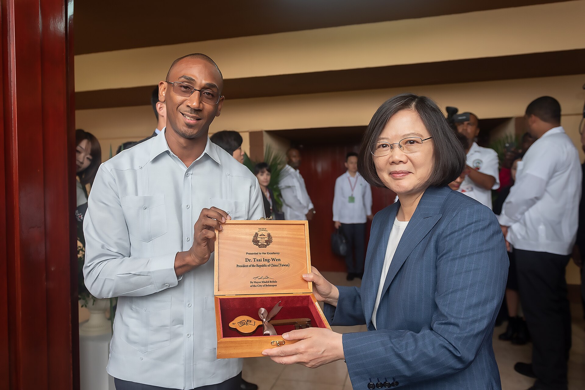 Taiwan's President Tsai Ing-wen holding an engraved wooden case with the key to the city of Belmopan beside the city's mayor