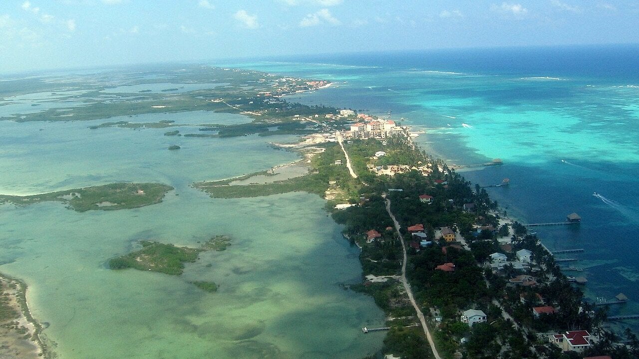 Aerial view of Ambergris Caye and San Pedro in Belize, with a lagoon on one side and the Caribbean Sea on the other