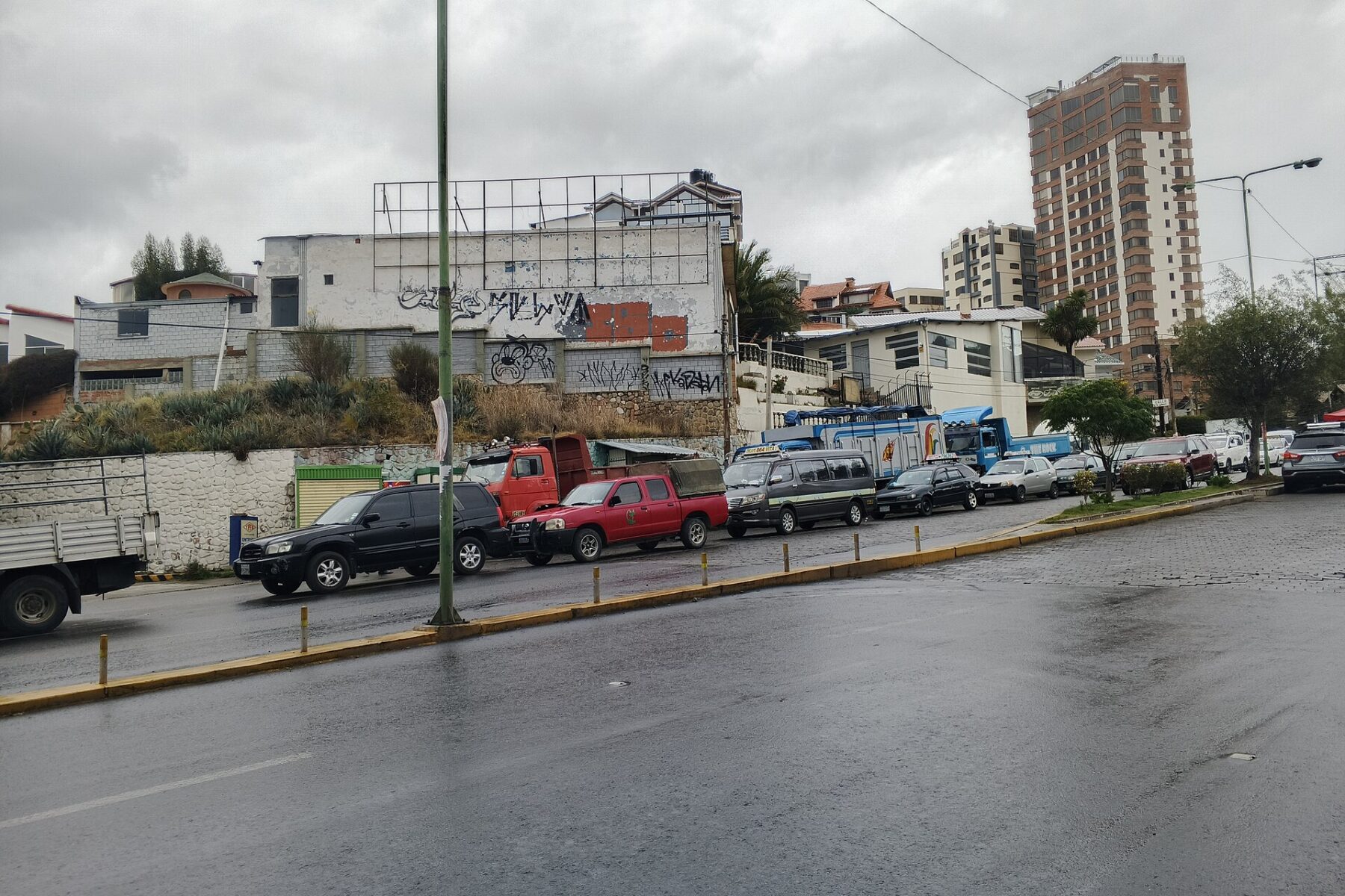 Cars, minibuses and trucks queuing for fuel along a street in La Paz, Bolivia