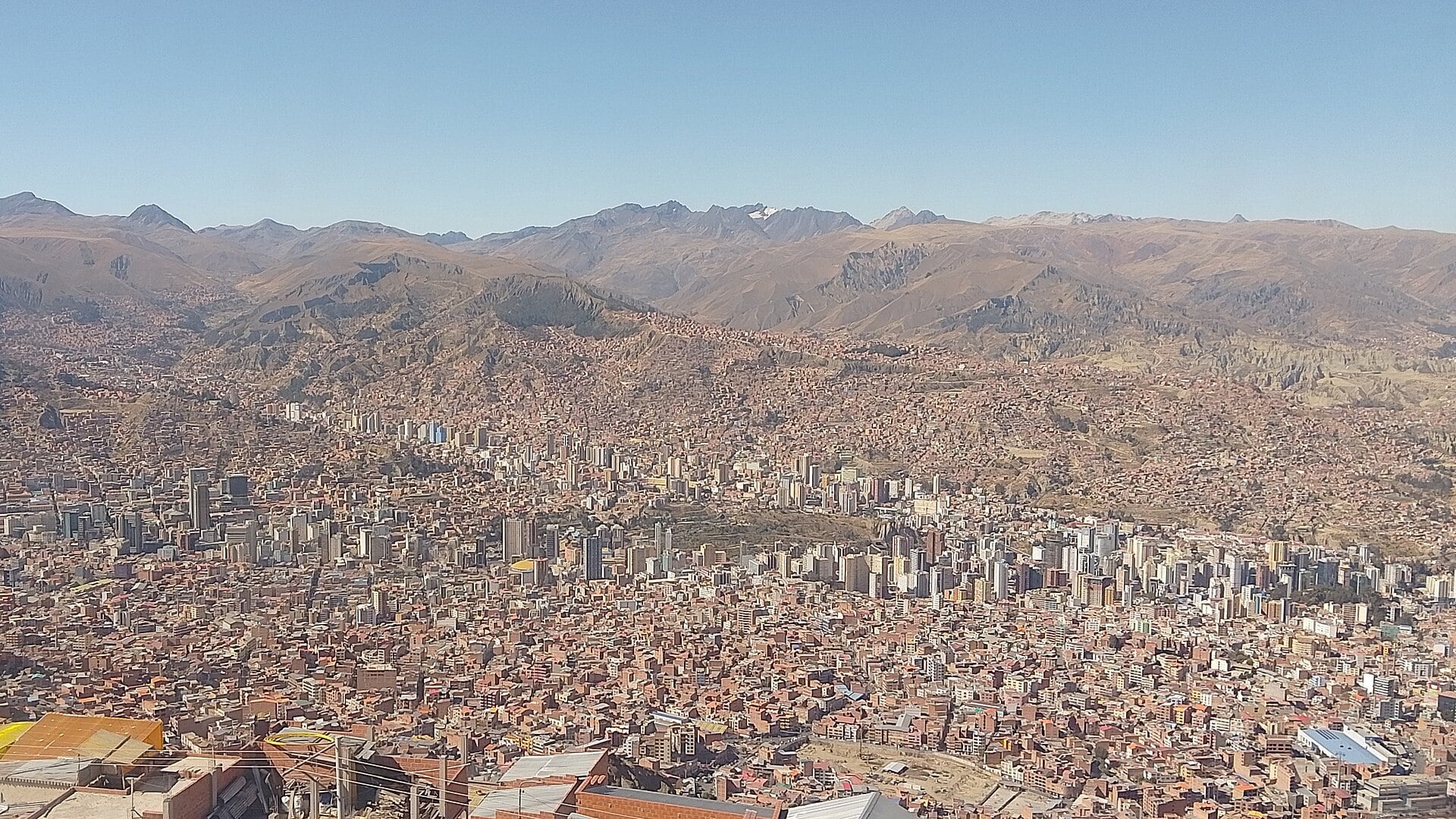 Panoramic view of La Paz, Bolivia, with high-rise buildings, dense housing and Andean peaks behind