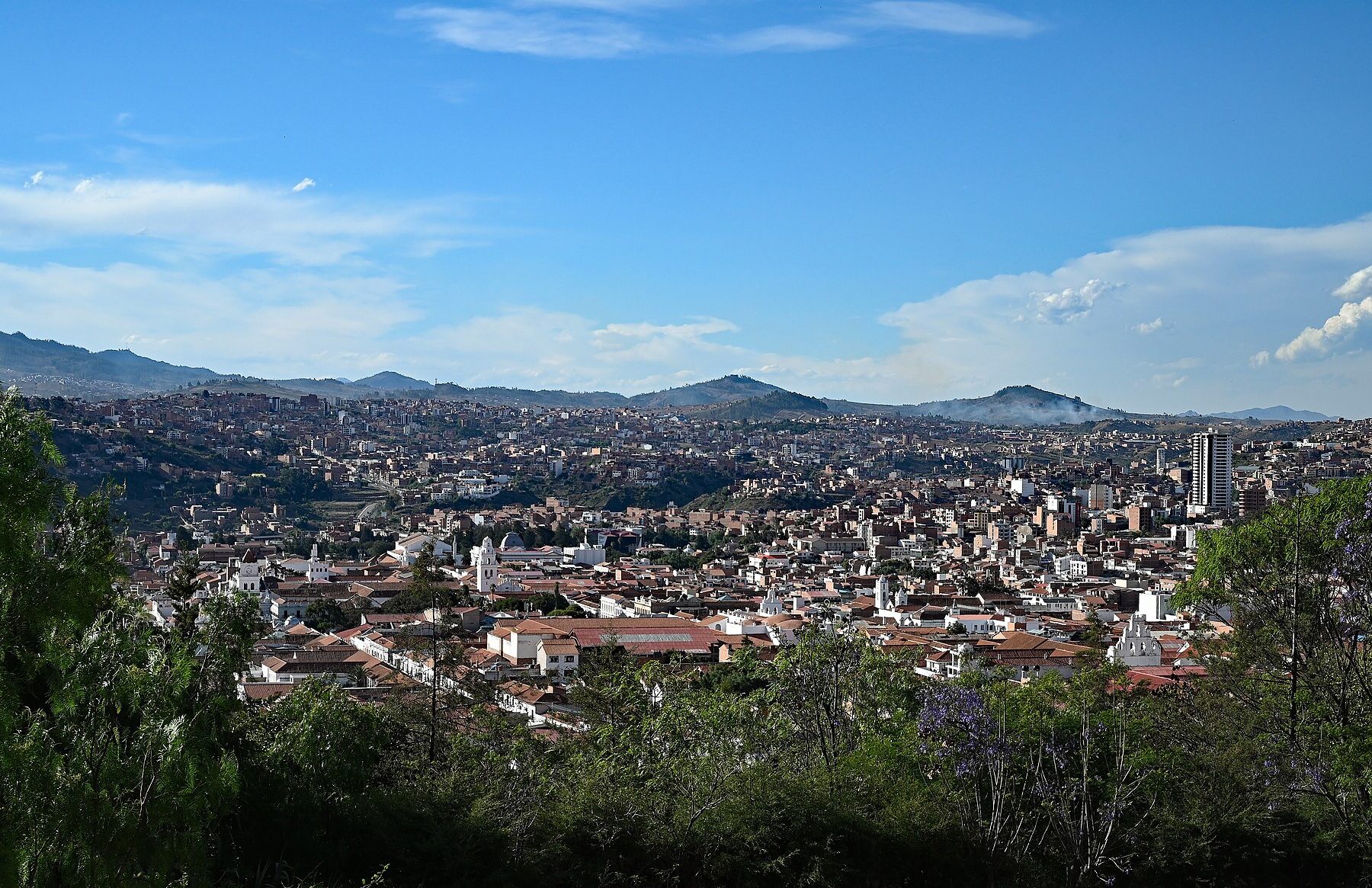 View over the rooftops of Sucre, Bolivia, with hills behind the city