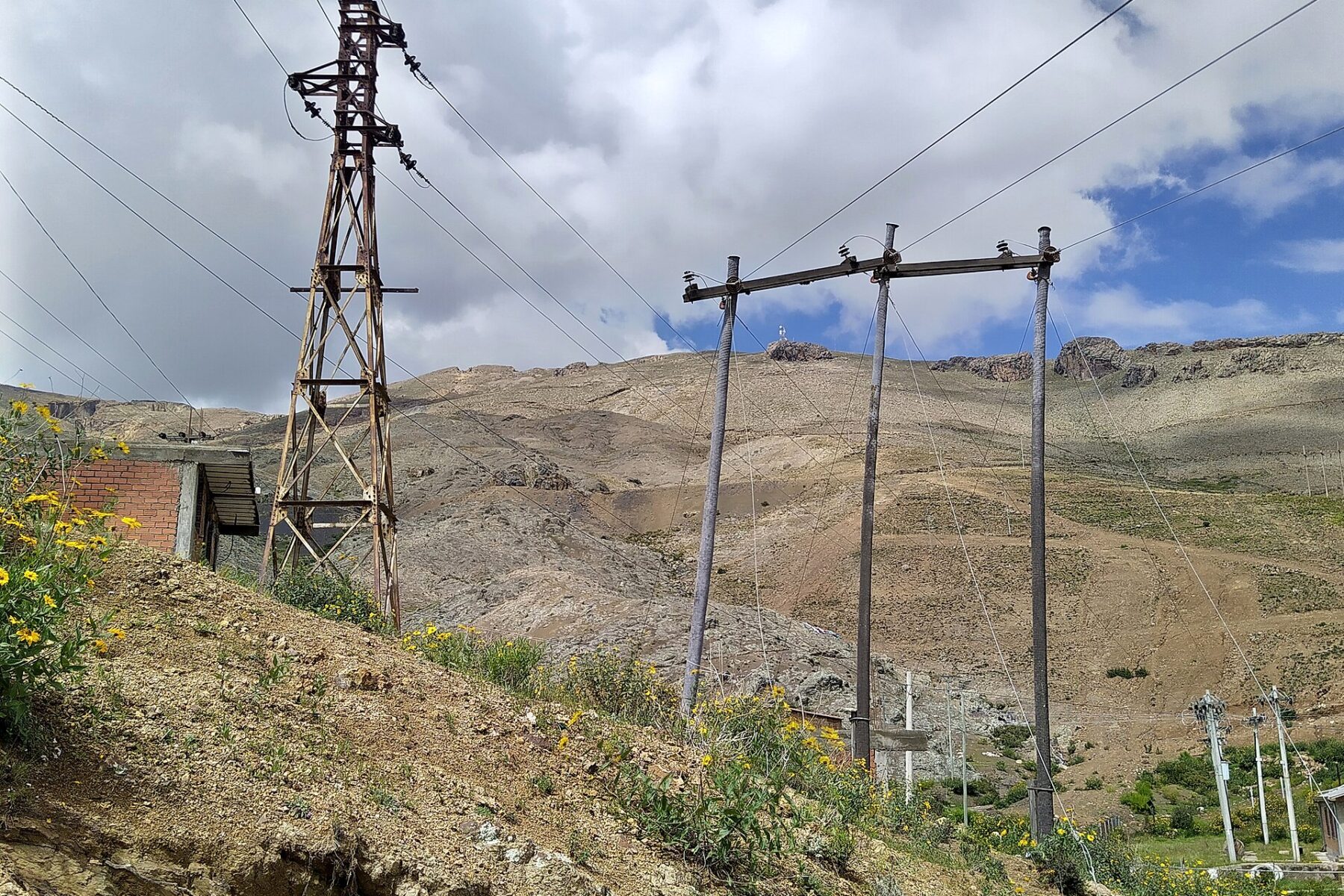 Two old power lines on a hillside near Llallagua in Bolivia