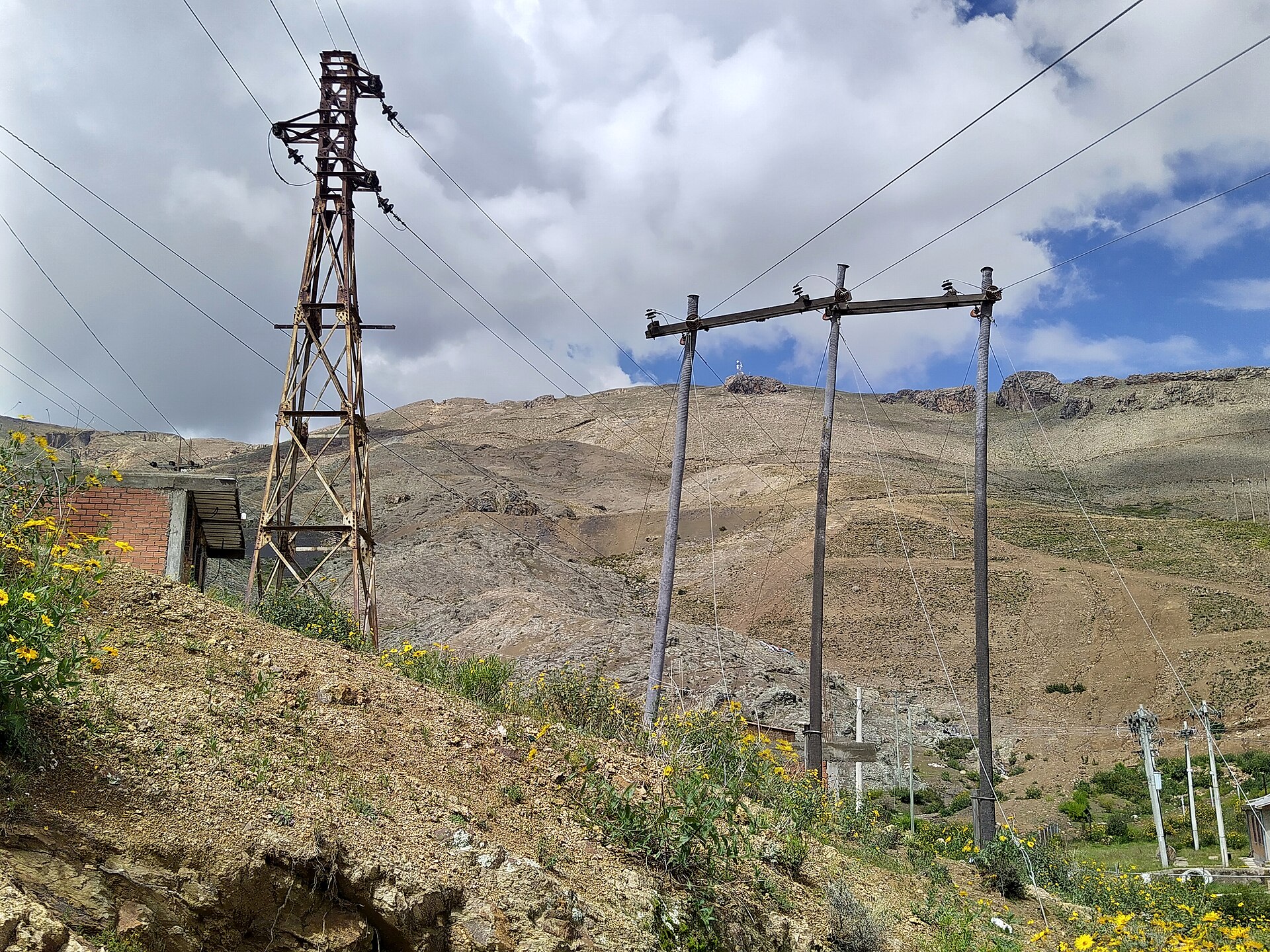 Two old power lines on a hillside near Llallagua in Bolivia