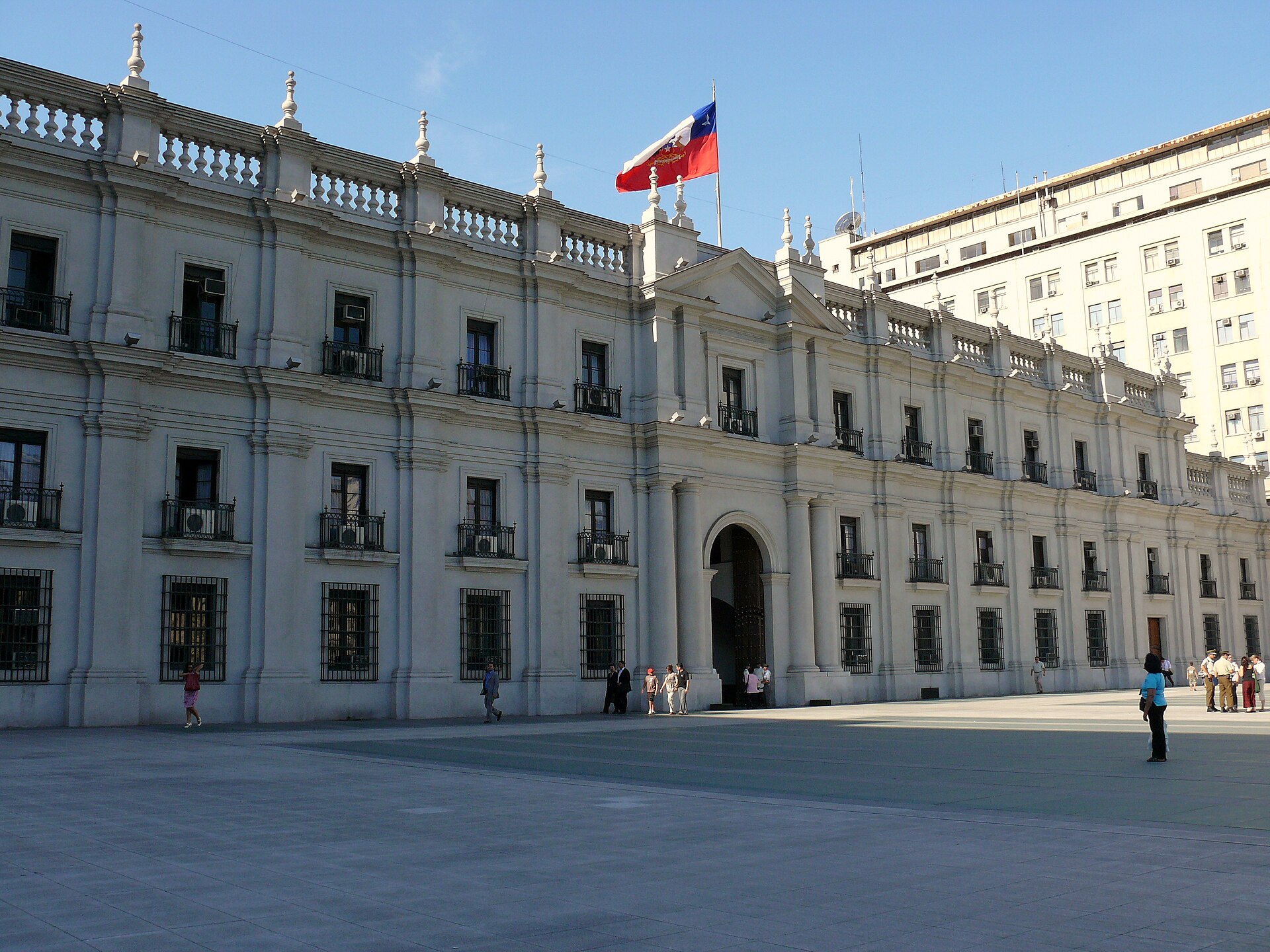 The Palacio de La Moneda, the presidential palace in Santiago, Chile, with the Chilean flag