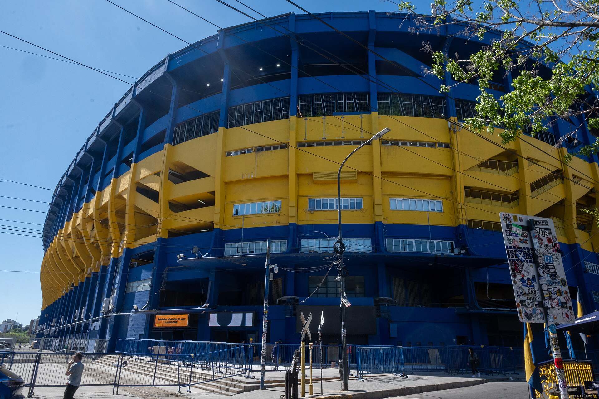 The blue and yellow outer wall of La Bombonera stadium in the La Boca district of Buenos Aires on a sunny day