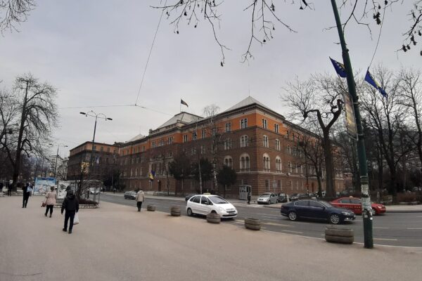 The Presidency building of Bosnia and Herzegovina in Sarajevo, an orange and brown stone building with the national flag