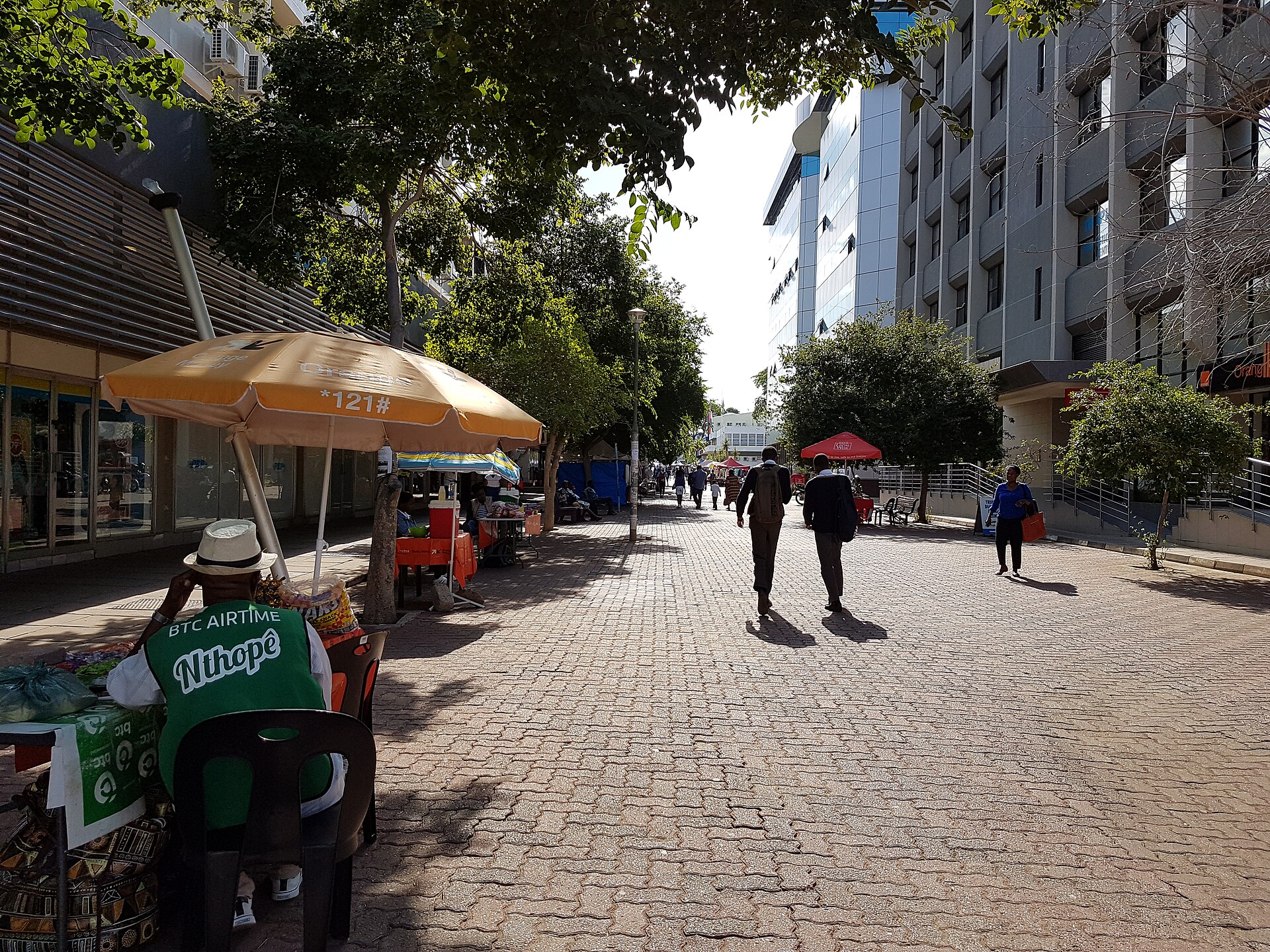 Pedestrians and street vendors in the Main Mall in central Gaborone, Botswana