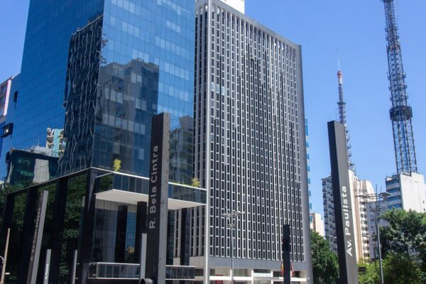Glass and concrete office towers at the corner of Avenida Paulista and Rua da Consolacao in Sao Paulo under a blue sky