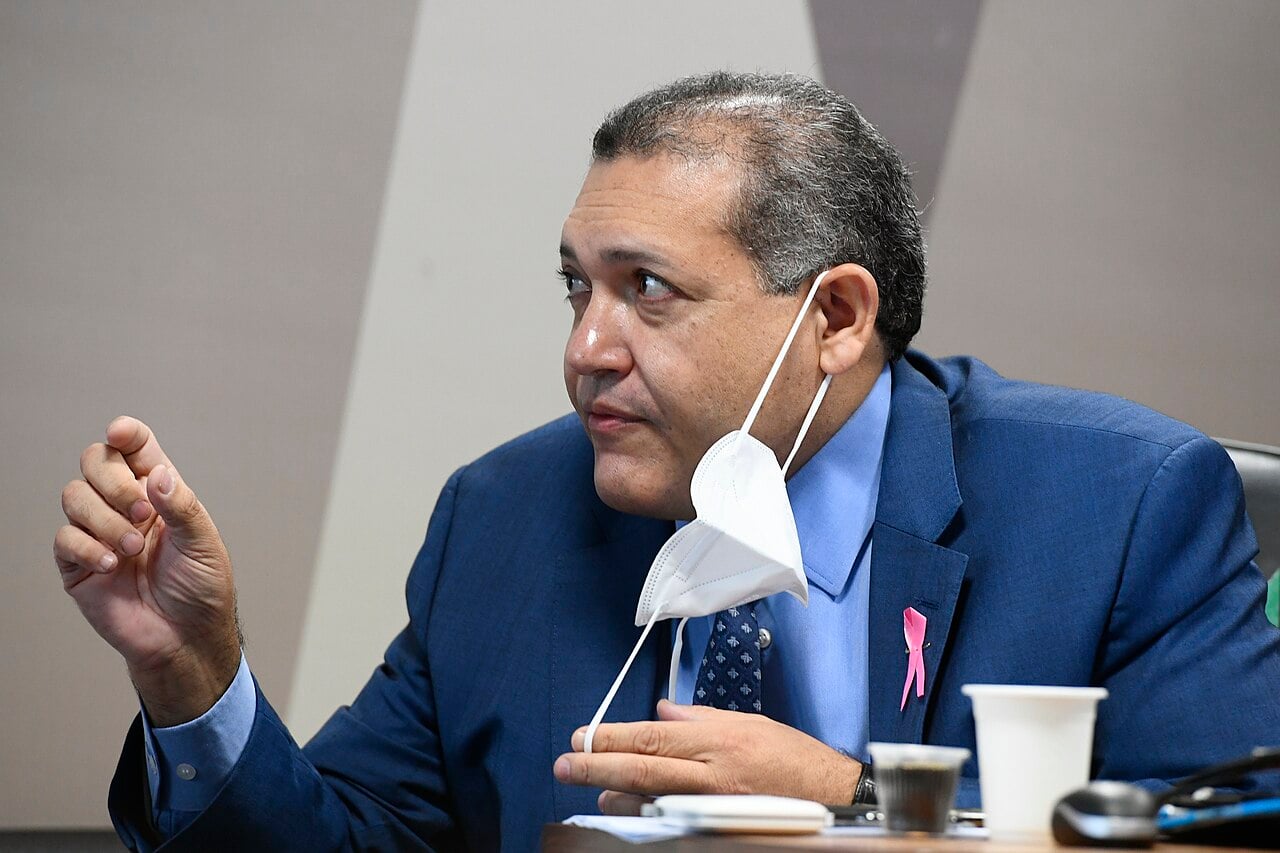 Kassio Nunes Marques in a blue suit, holding a face mask, speaking at a Senate committee table
