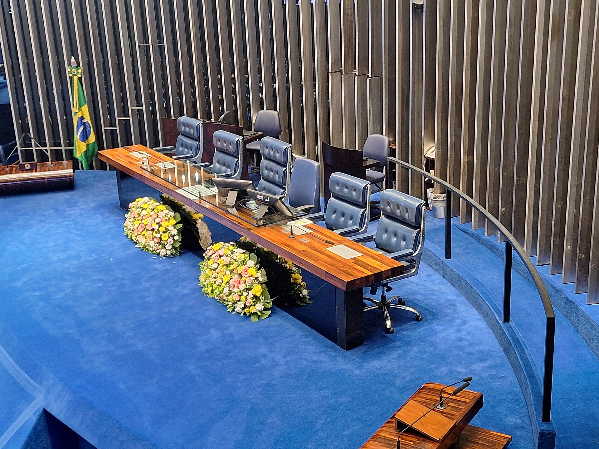 The presiding table and blue carpet of the Federal Senate plenary chamber in Brasília