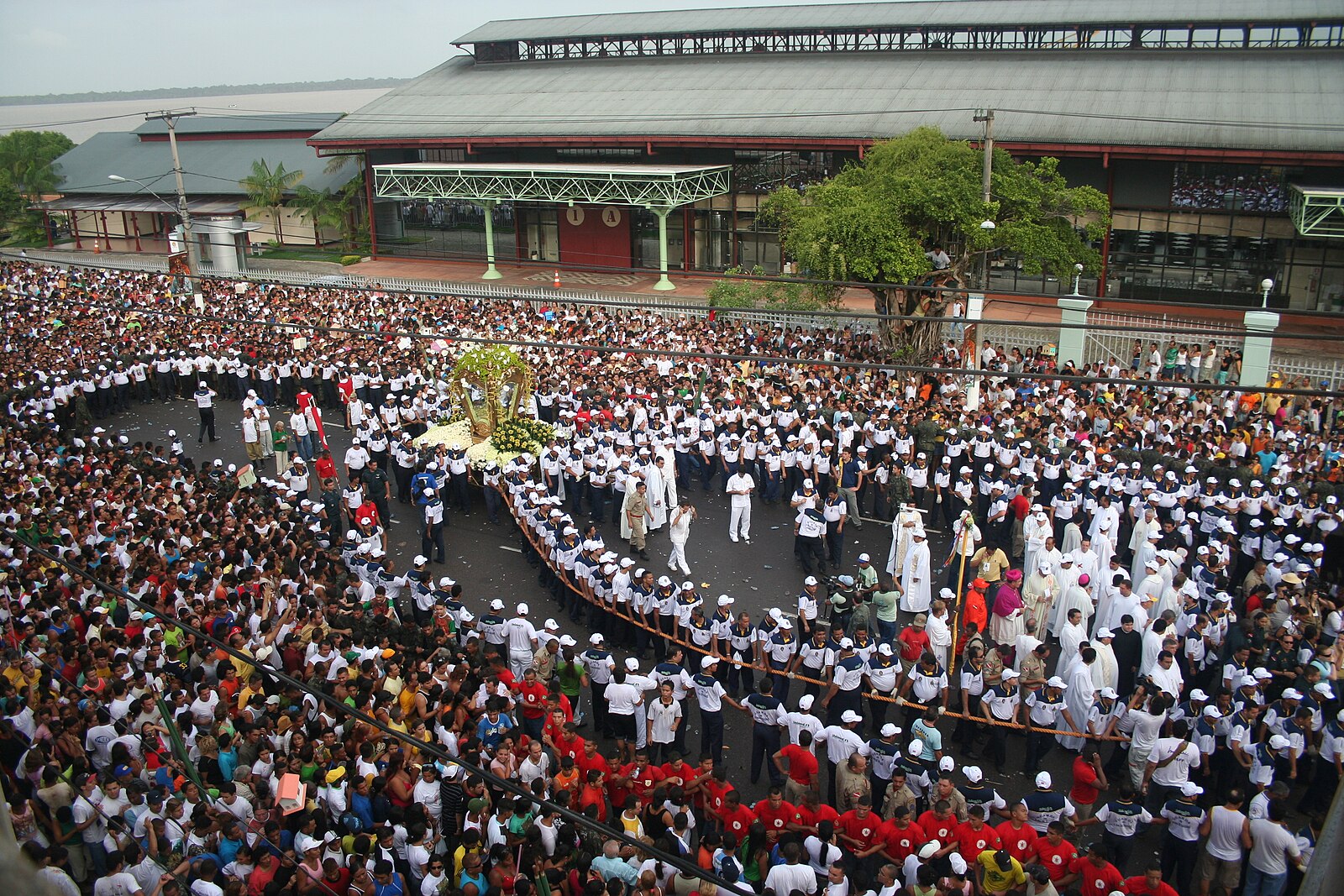 Brazil religion: pilgrims hold the rope around the image of Our Lady of Nazareth during the Círio procession in Belém