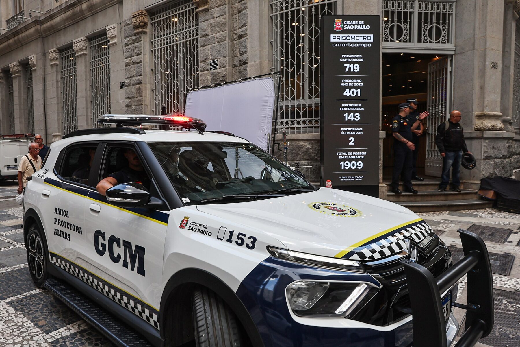 A Guarda Civil Metropolitana patrol car outside the Smart Sampa transparency display in central Sao Paulo, Brazil