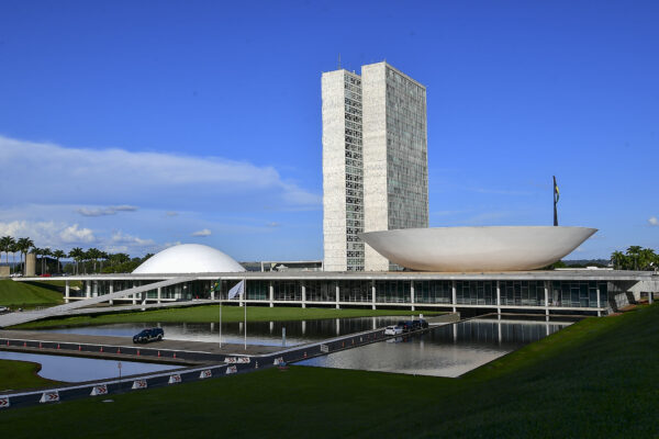 The National Congress in Brasília with its twin towers, Senate dome and Chamber of Deputies bowl under a blue sky