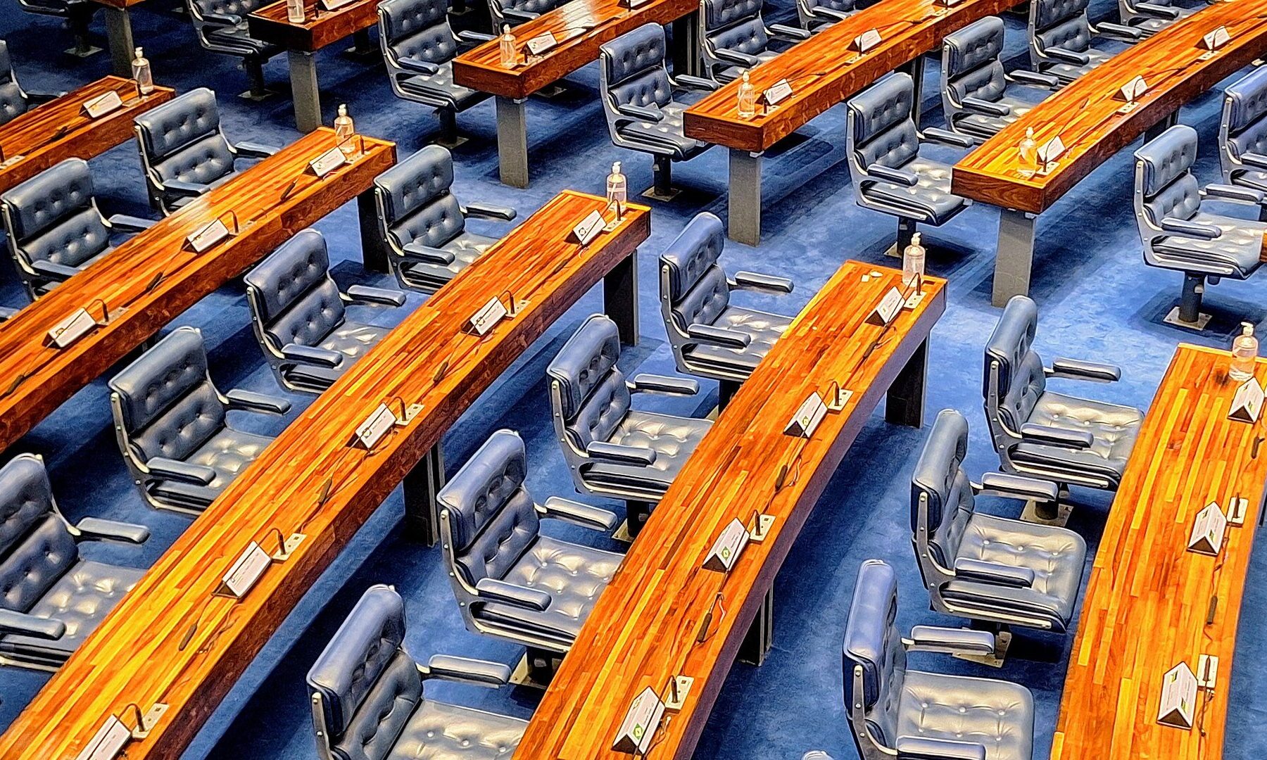 Rows of blue leather seats and curved wooden desks in the plenary of Brazil's Federal Senate in Brasilia