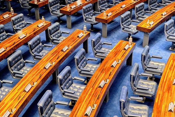 Rows of blue leather seats and curved wooden desks in the plenary of Brazil's Federal Senate in Brasilia