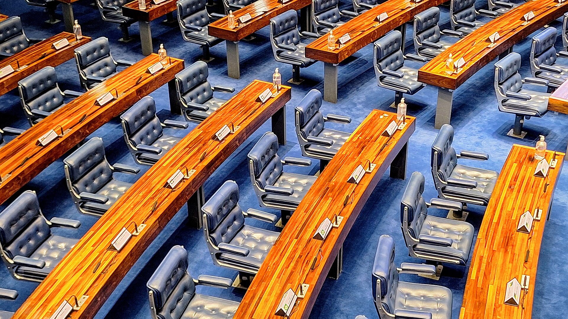 Rows of blue leather seats and curved wooden desks in the plenary of Brazil's Federal Senate in Brasilia