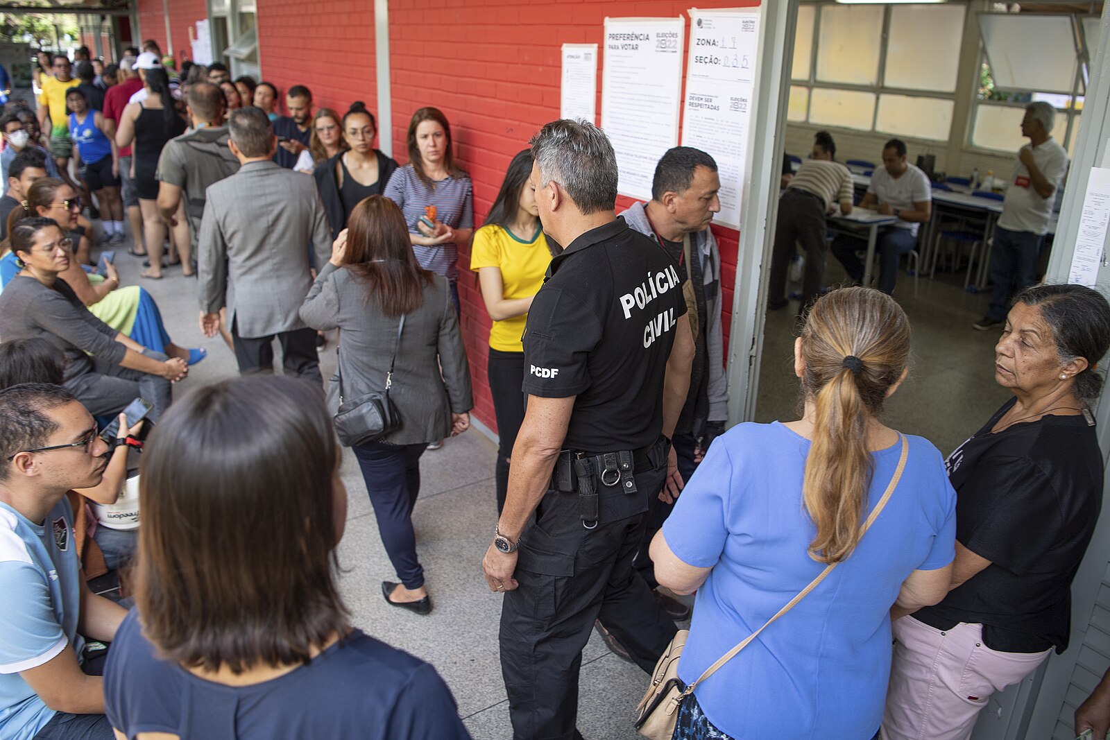 Voters walk along the outdoor corridor of a polling station school in Gama, Federal District, on 30 October 2022