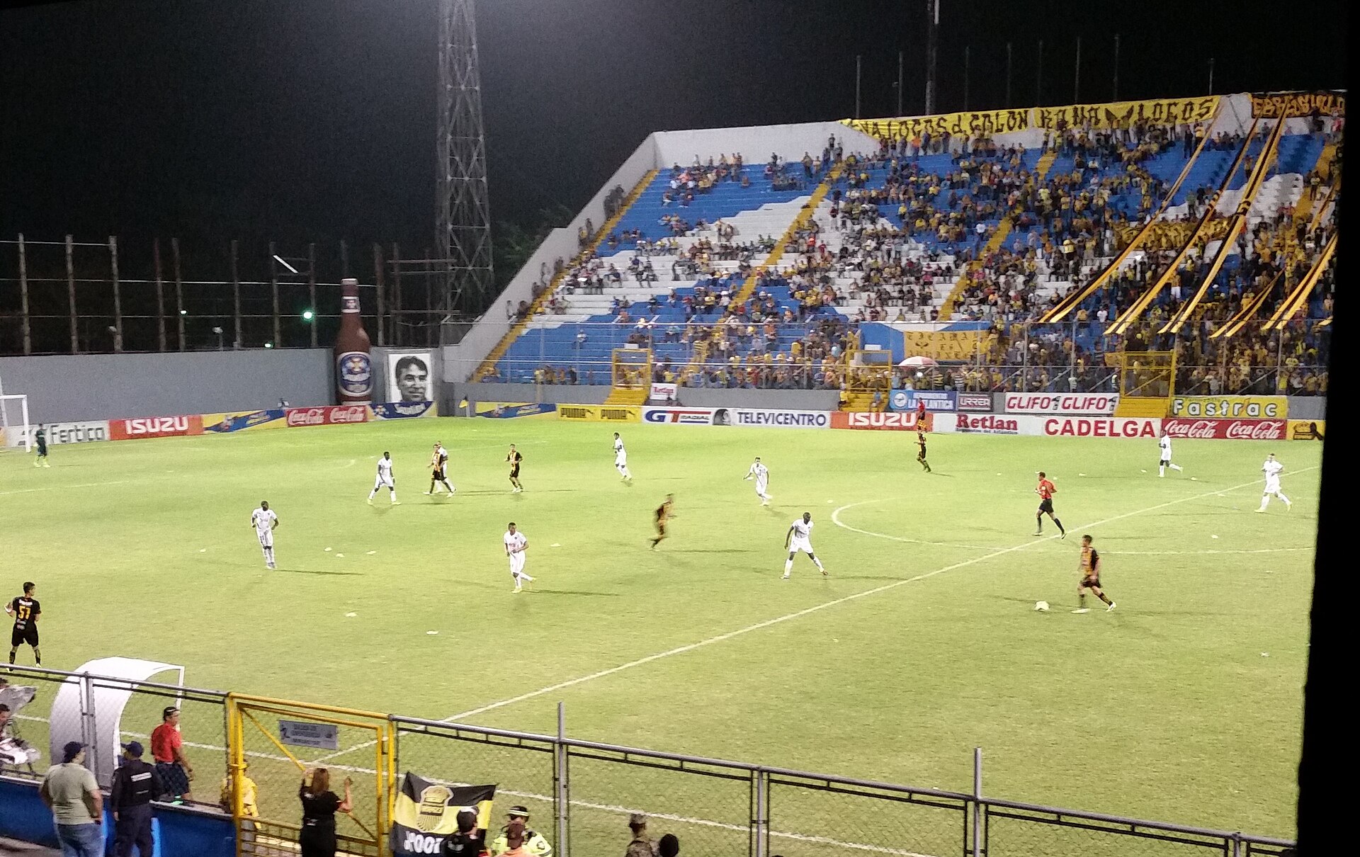 Players on the pitch and fans in the stands during a Liga Nacional match between Olimpia and Real España in Honduras, May 2015