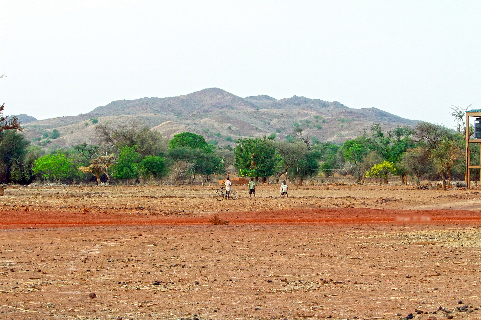 A hill and red-earth fields near Sakondé village in northern Burkina Faso