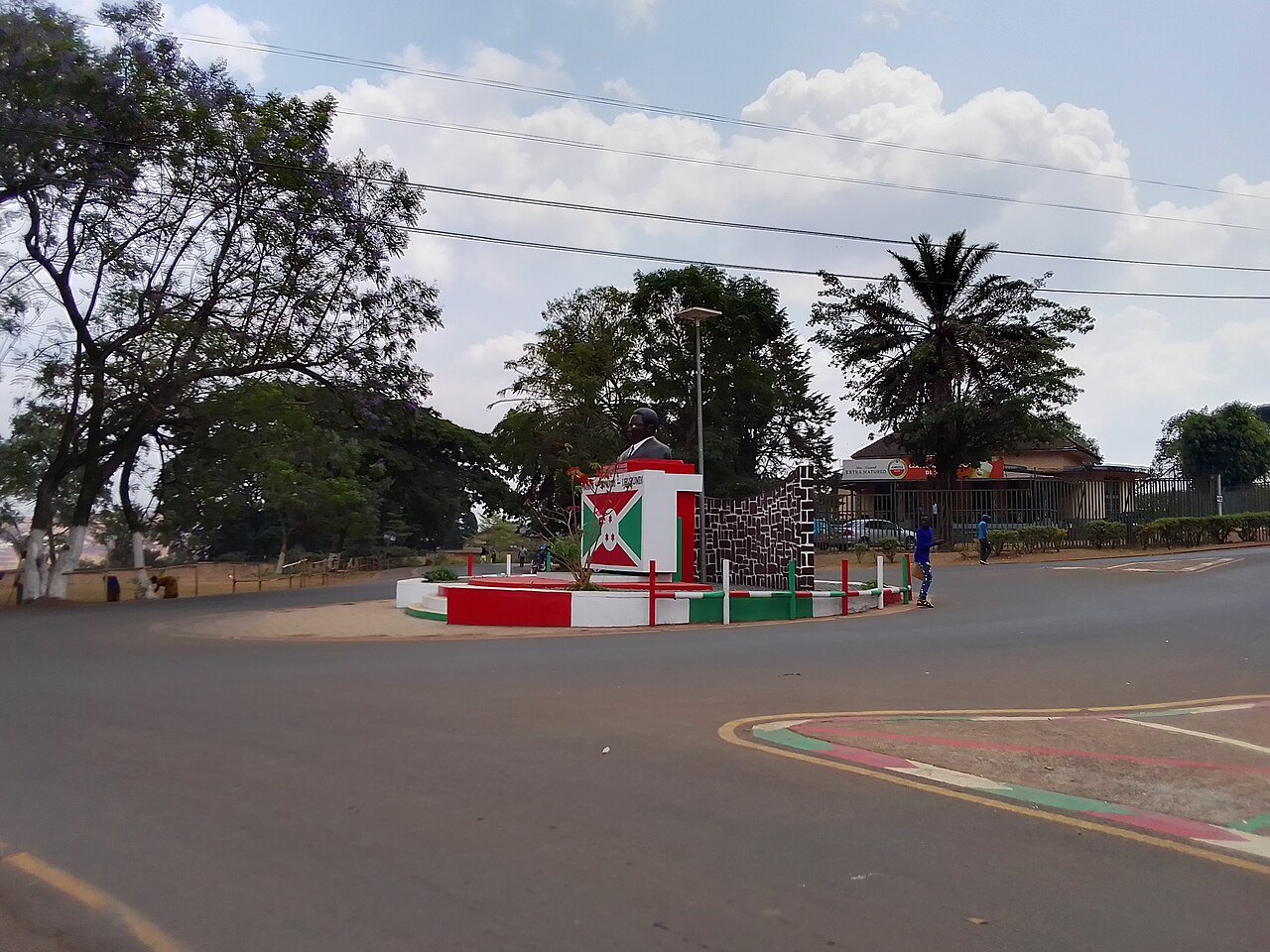 A roundabout with a monument painted in the red, white and green of Burundi's flag in central Gitega