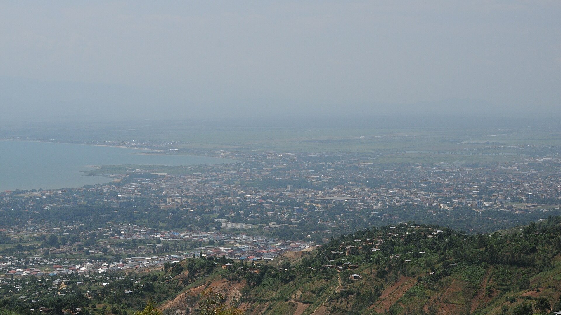 Bujumbura and the shore of Lake Tanganyika seen from the hills above the city, with the Ruzizi plain in the distance.