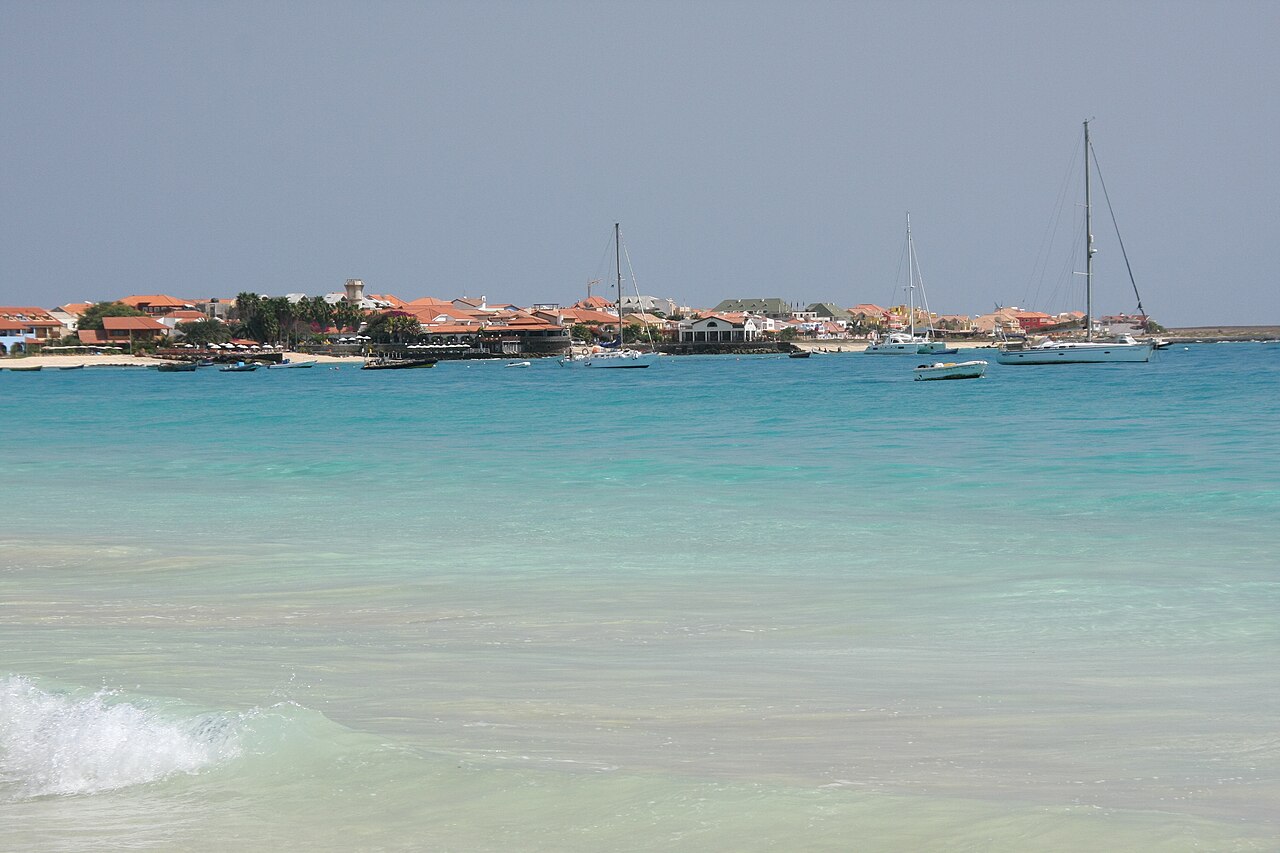 Turquoise bay with anchored sailboats in front of the resort town of Santa Maria on the island of Sal, Cabo Verde