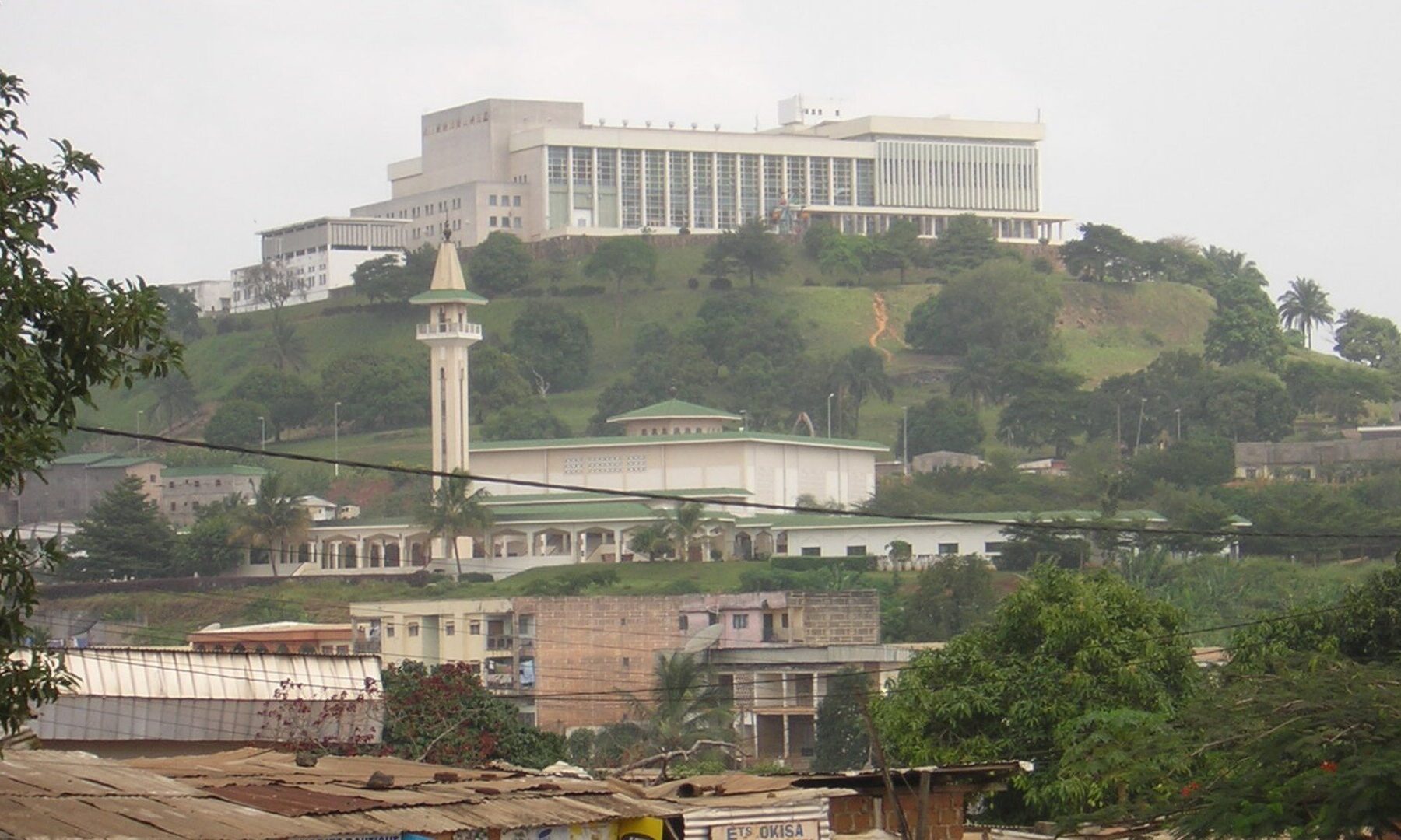 The Palais des Congrès on a hill in Yaoundé, Cameroon, with the Briqueterie mosque below it
