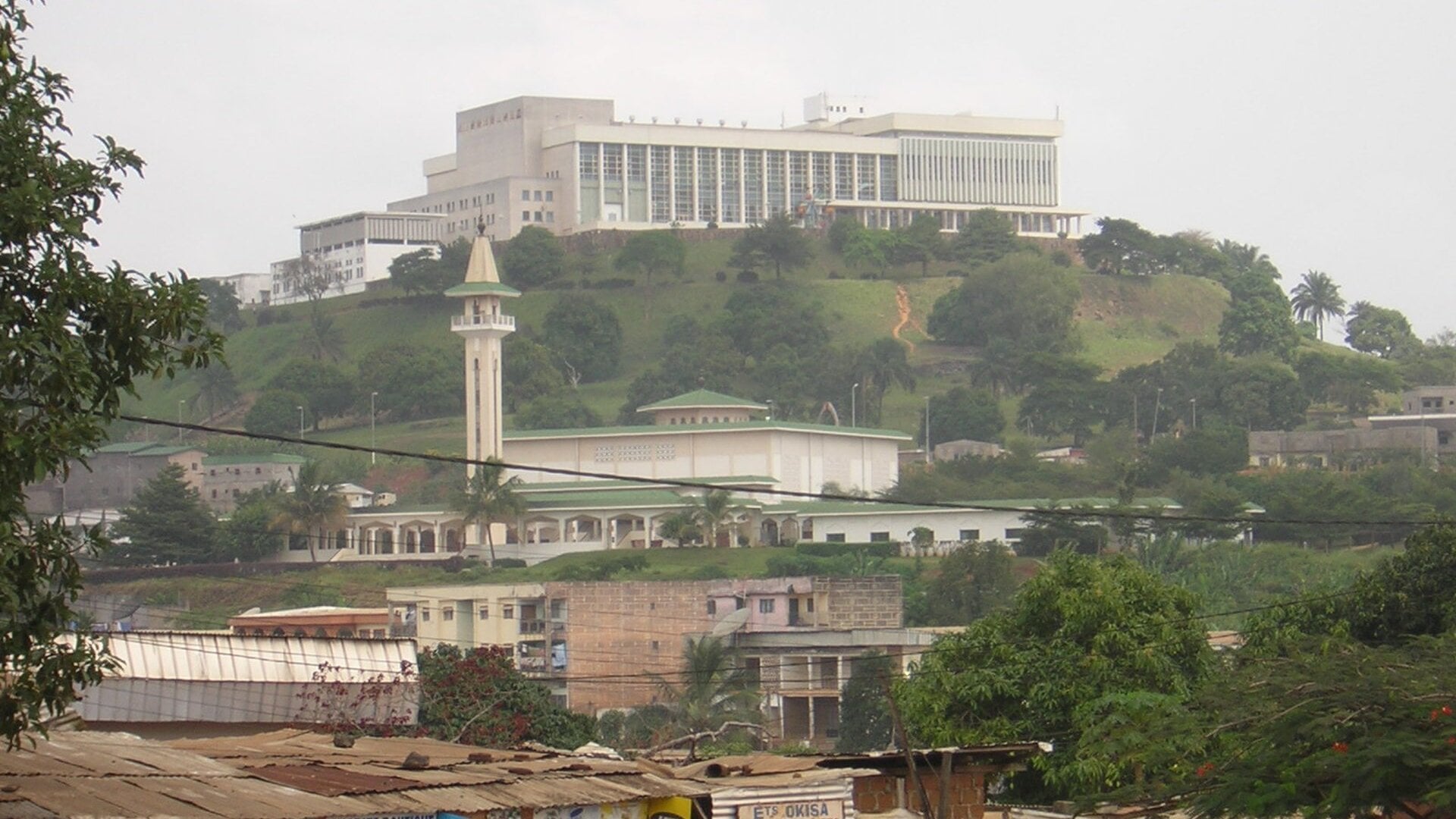 The Palais des Congrès on a hill in Yaoundé, Cameroon, with the Briqueterie mosque below it