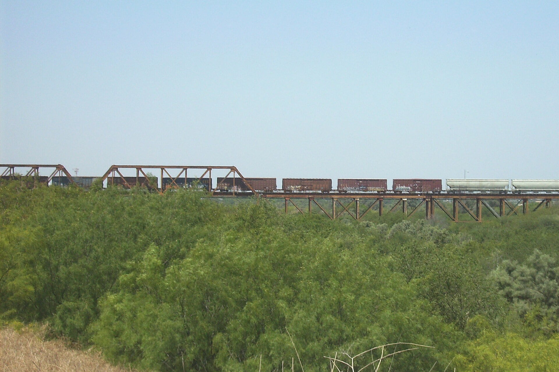 A freight train crosses the Texas Mexican Railway International Bridge between Nuevo Laredo and Laredo