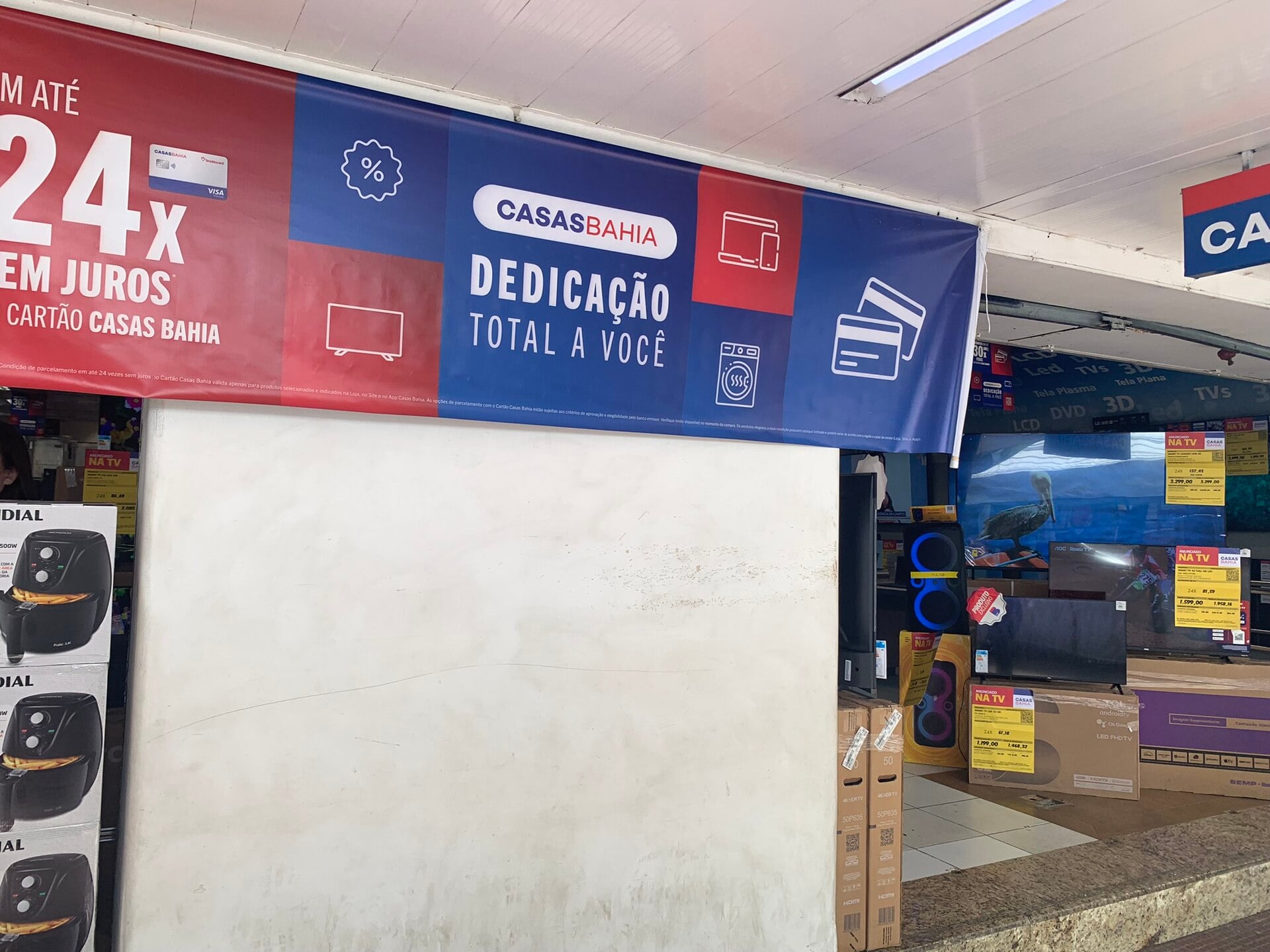 A Casas Bahia banner offering 24 interest-free instalments above a television display inside a store in Nova Friburgo, Brazil