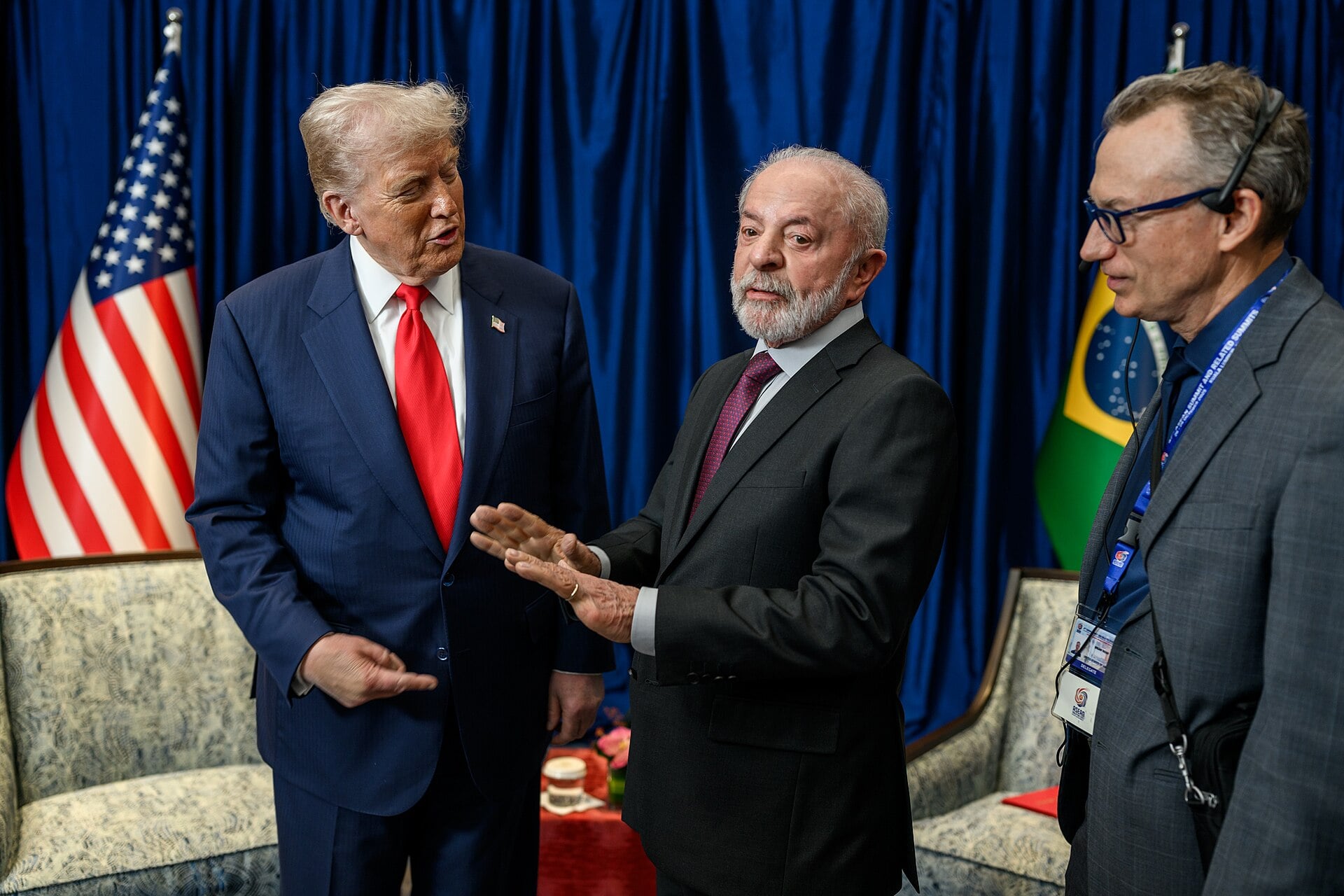 President Donald Trump and President Lula talk beside the US and Brazilian flags at the ASEAN summit in Kuala Lumpur on 25 October 2025
