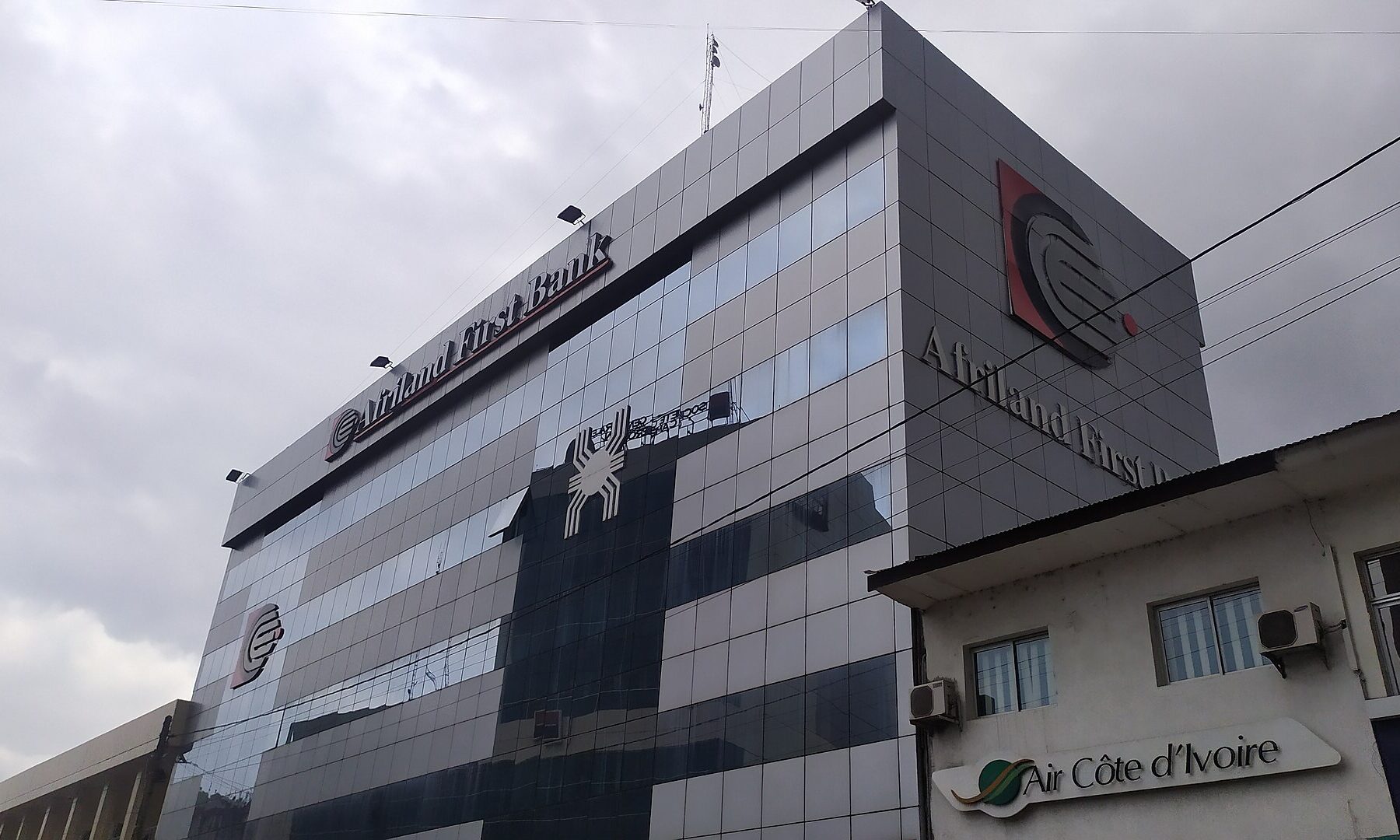 An Afriland First Bank office building in Cameroon under a grey sky