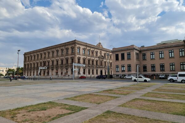 Historic government buildings on the Plaza Mayor in Chihuahua City, Mexico, under a cloudy sky